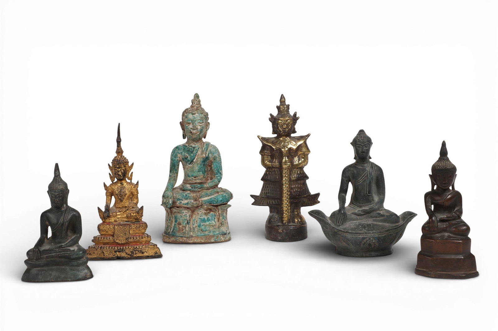 Six Southeast Asian bronze, ceramic and metalware models of Buddha and Tosakan: Six Southeast Asian bronze, ceramic and metalware models of Buddha and Tosakanlargest height 8 1/4in (21cm); width 4in (10cm); depth 2 3/4in (7cm) Provenance:Property from the Preiser Collection.