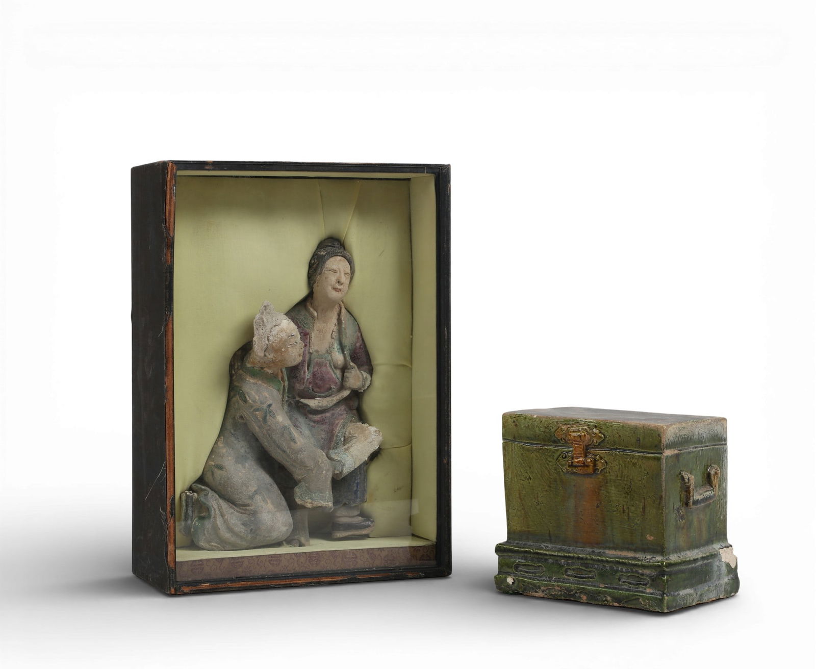 Two Chinese glazed ceramic articles: Two Chinese glazed ceramic articlesComprising a mudmen figural group fragment in fitted case and a sancai glazed model of a chest.figural group height 9 1/4in (23cm); width 6 1/2in (16cm); depth 3 3/4