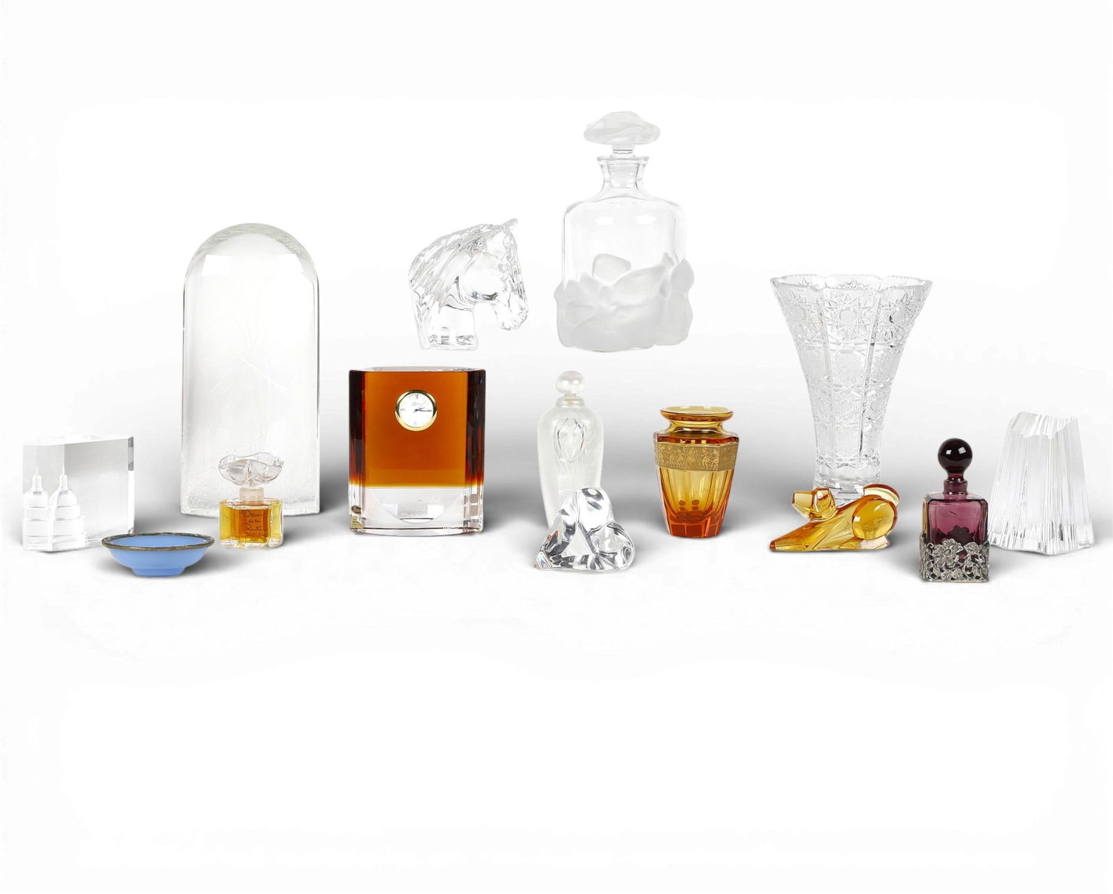 A group of fourteen glass table articles: A group of fourteen glass table articlesIncluding works by Steuben, Moser and others.Dragonfly ornament; height 10 1/4in (27cm); width 5in (13cm); depth 2 1/4in 5.5cm) Provenance:Property from a Priv