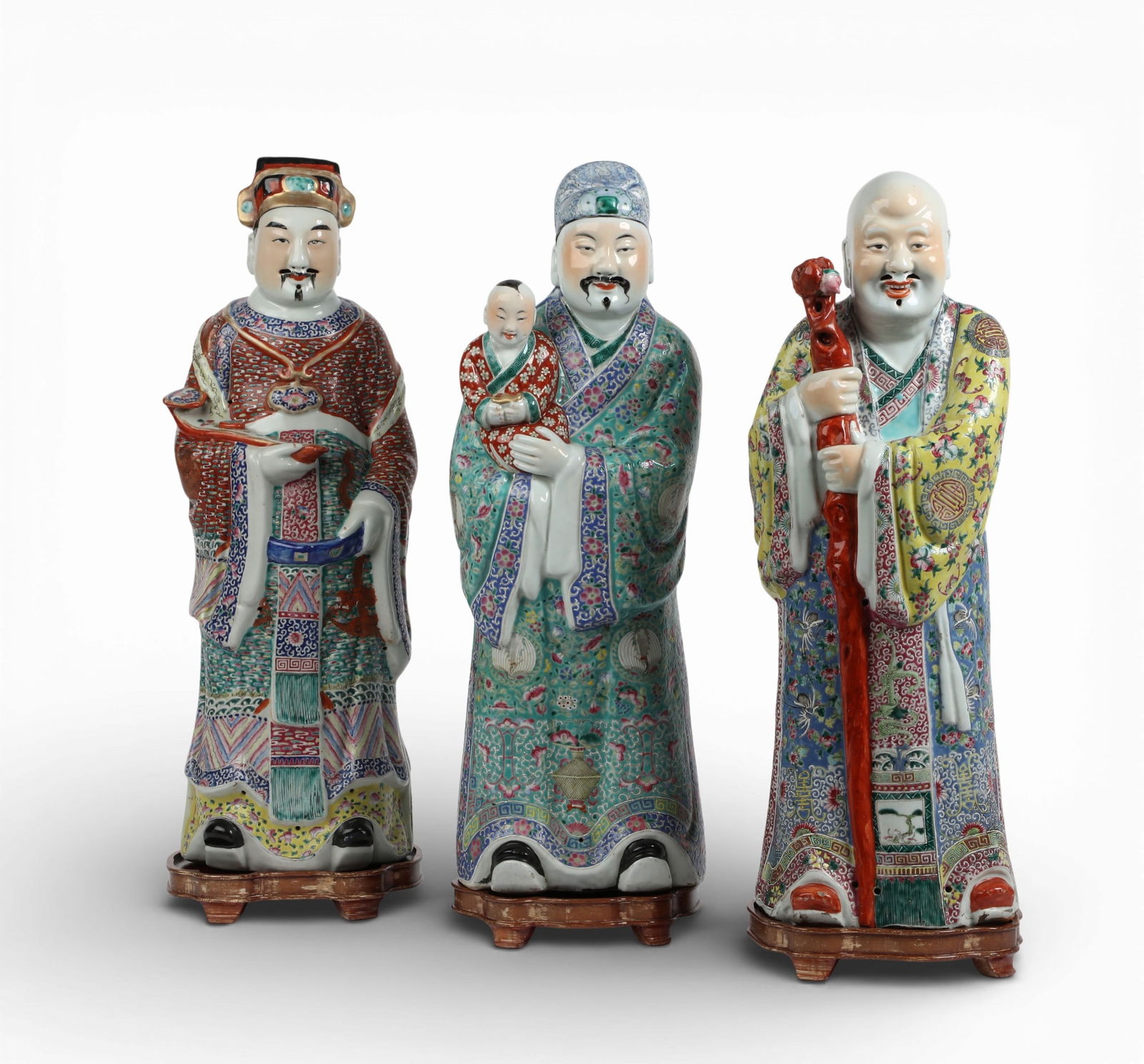 A group of three Chinese famille rose porcelain figures on wood stands (1 of 7)