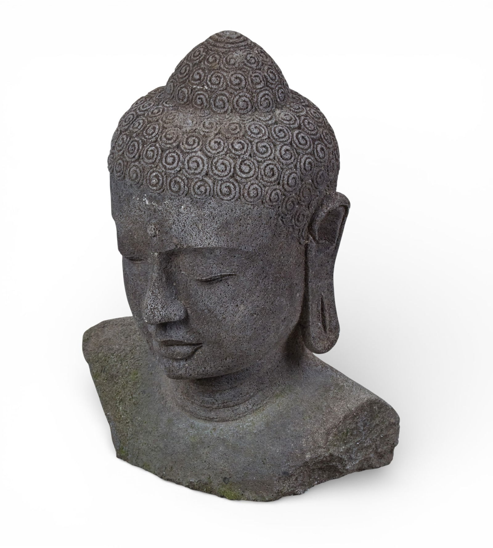 A carved stone Buddha head: A carved stone Buddha headheight 23 x width 16 x depth 12 in. (58.4 x 40.6 x 30.5 cm.)