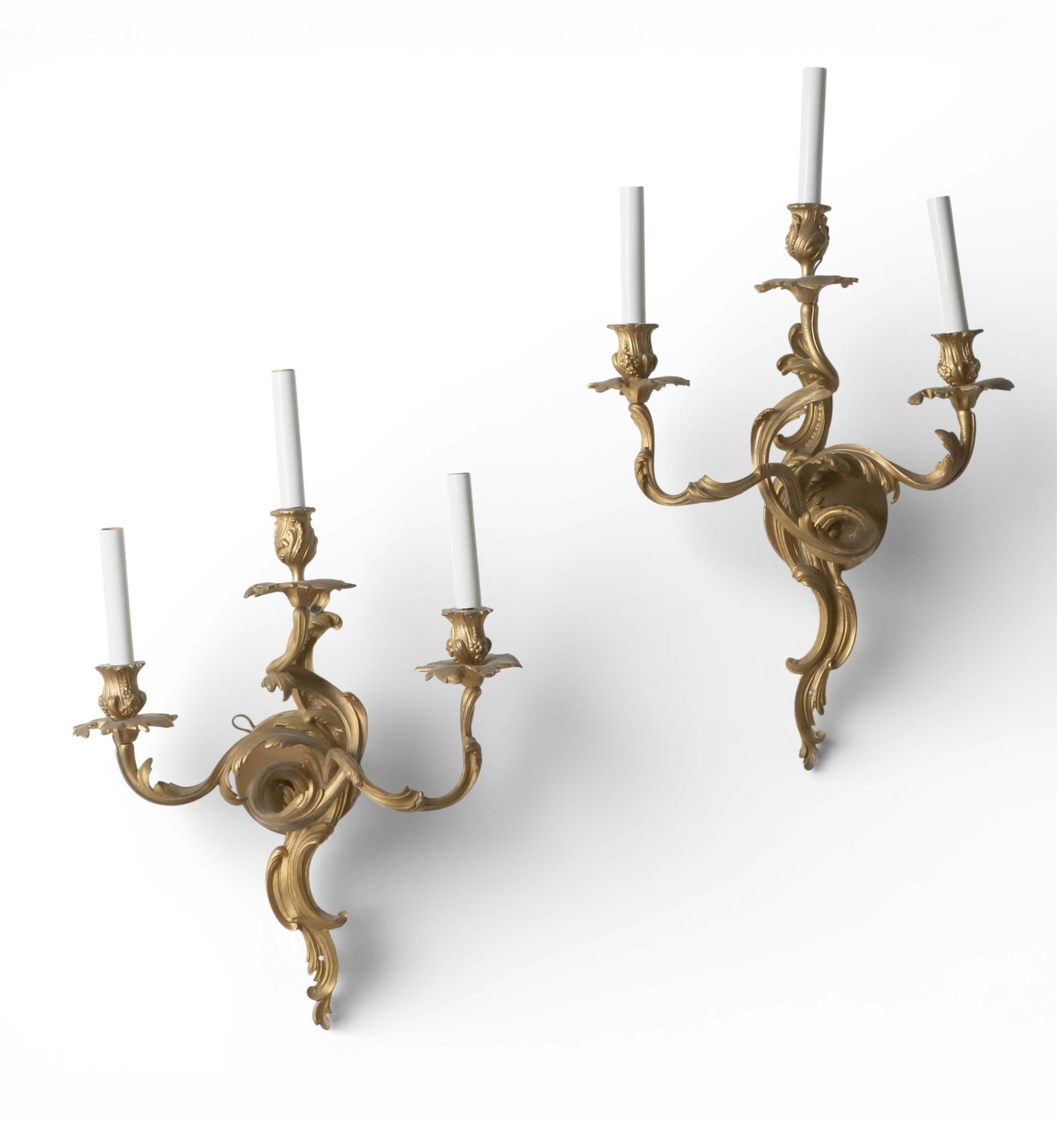 A pair of three light gilt bronze wall sconces: A pair of three light gilt bronze wall sconcesOverall: height 25 x width 15 in. (63.5 x 38.1 cm.)