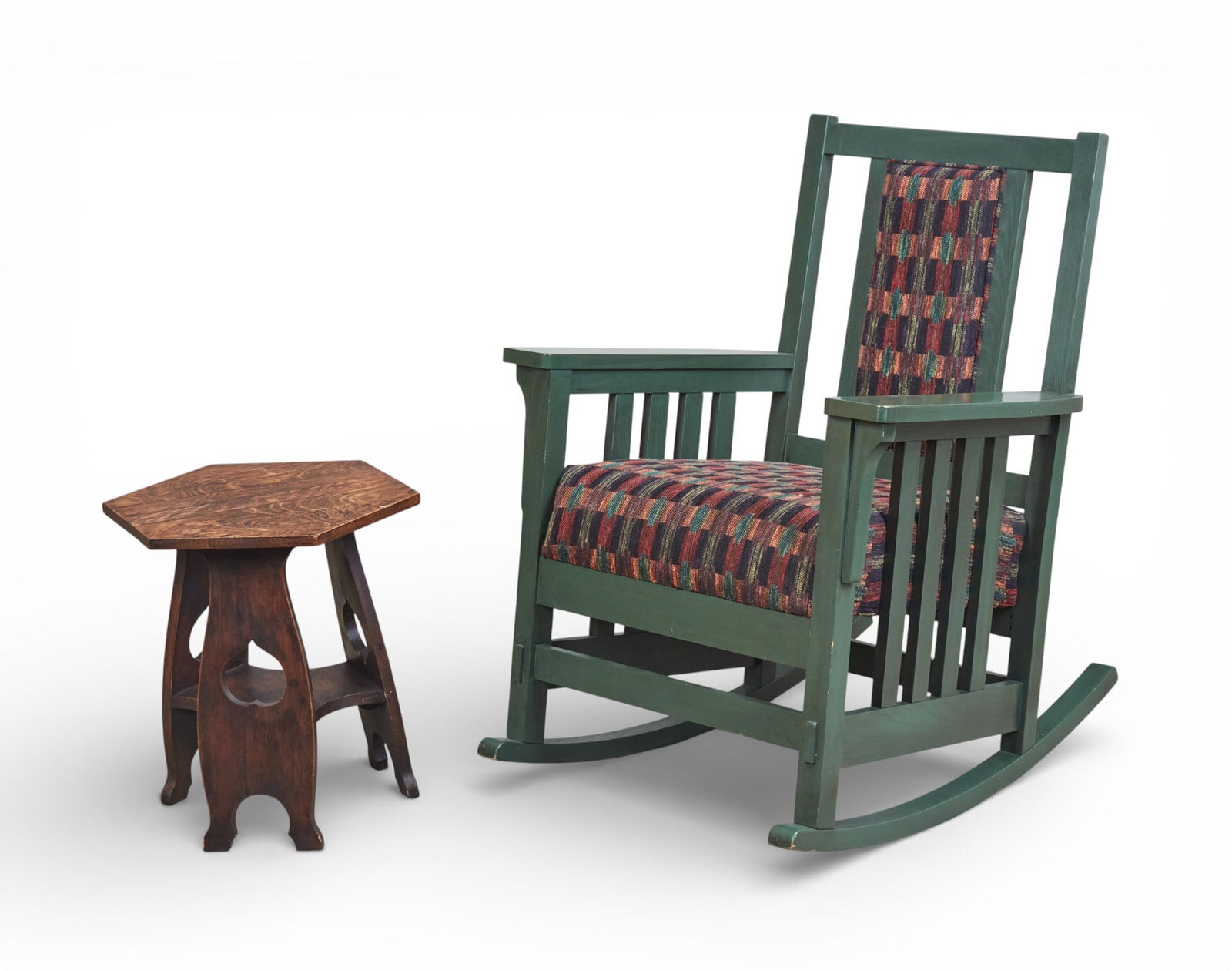An Arts and Crafts style green painted rocker and oak hexagonal side table: An Arts and Crafts style green painted rocker and oak hexagonal side table(2)rocker height 37in (92.5cm); width 29in (72.5cm); depth of seat 20in (50cm) Provenance:Property from a Private Collection,
