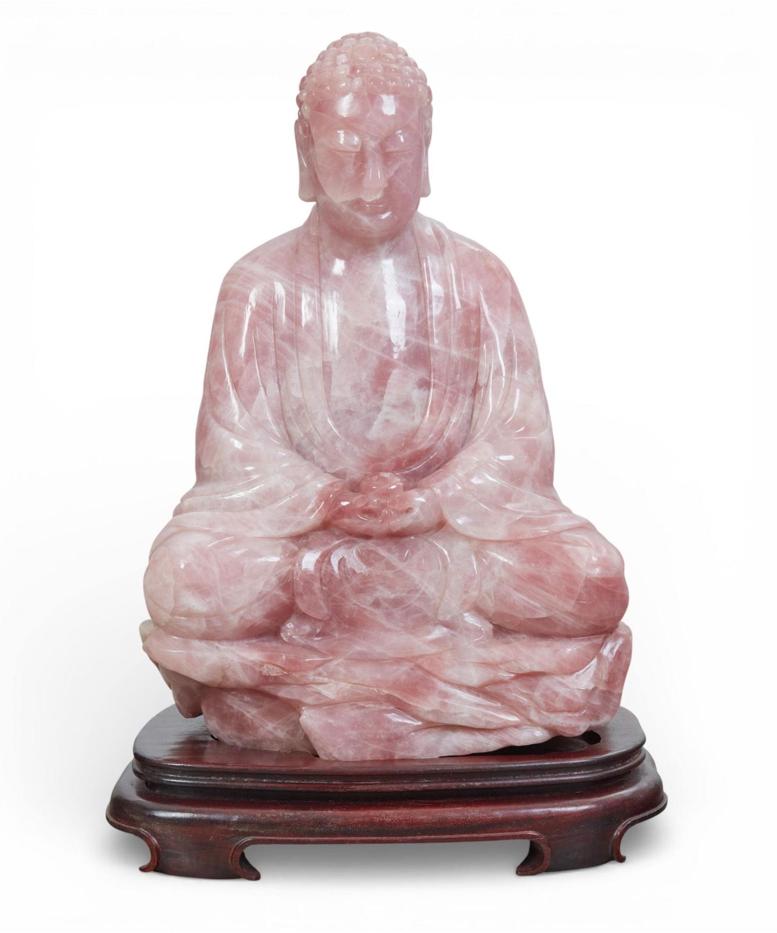 A large Chinese rose quartz seated Buddha on wooden stand: A large Chinese rose quartz seated Buddha on wooden standBuddha: height 21 x width 14 x depth 10 in. (53.3 x 35.6 x 25.4 cm.)