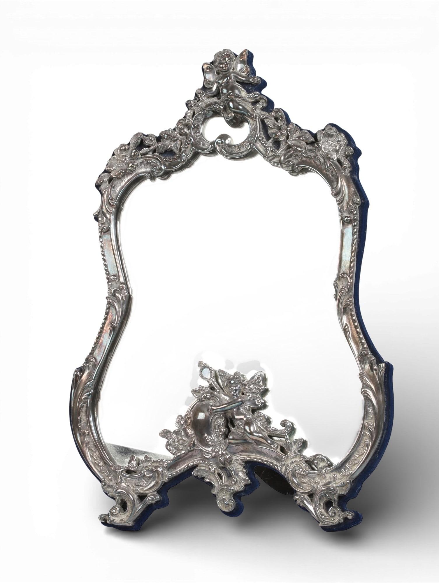 A sterling silver vanity mirror: A sterling silver vanity mirror20 x 14 in. (50.8 x 35.6 cm.)
