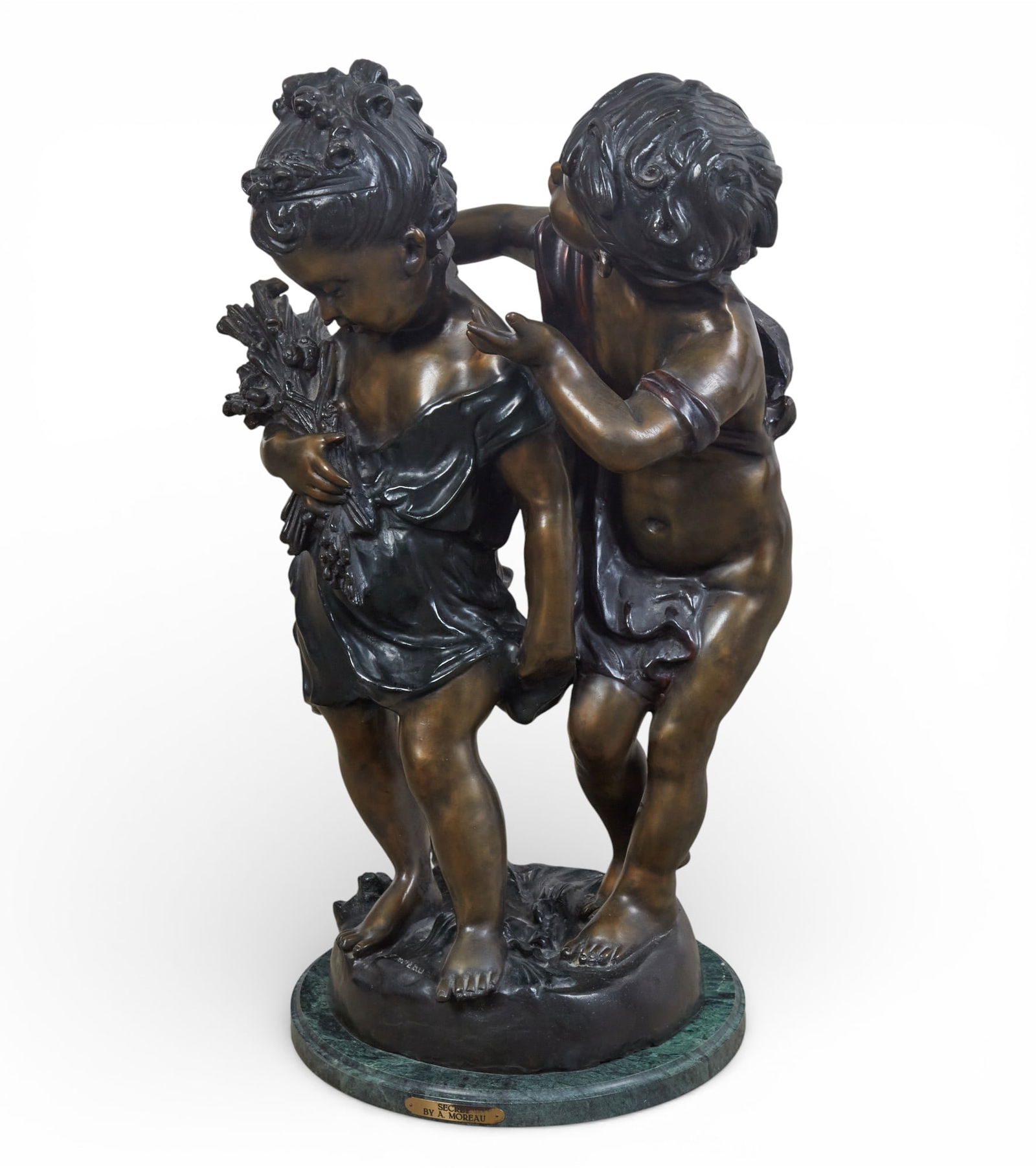 A bronze statue of a boy and a girl: A bronze statue of a boy and a girl height 35 x width 20 in. (88.9 x 50.8 cm.)