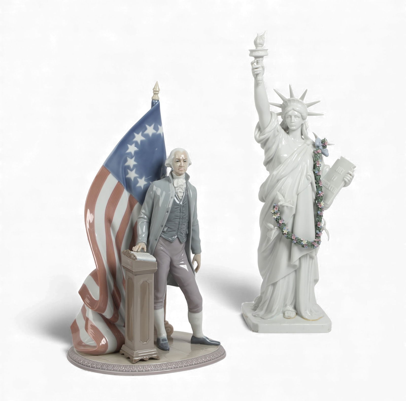 Two Lladro figures; George Washington and The Statue of Liberty: Two Lladro figures; George Washington and The Statue of Liberty Liberty; height 20 1/2in (52cm); width 7 1/2in (19cm); depthin (15cm) Provenance: Property from a Private Collection, Beverly Hills,