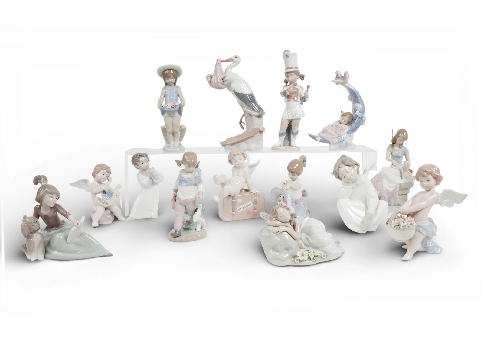 A group of fourteen Lladro figures: A group of fourteen Lladro figures Stork; height 10in (25.5cm); width 4 1/4in (10.5cm); depth 6 1/2in (16.5cm) Provenance: Property from a Private Collection, Beverly Hills, California.