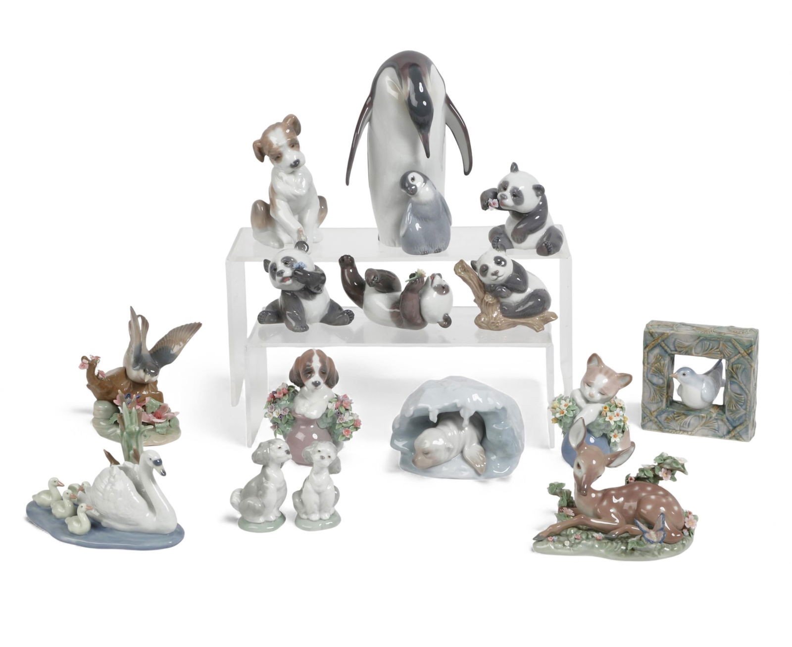 A group of fifteen Lladro figures of birds and animals: A group of fifteen Lladro figures of birds and animals Penguins; height 7 1/2in (19cm); width 5in (13cm); depth 4 1/4in (11cm) Provenance: Property from a Private Collection, Beverly Hills,