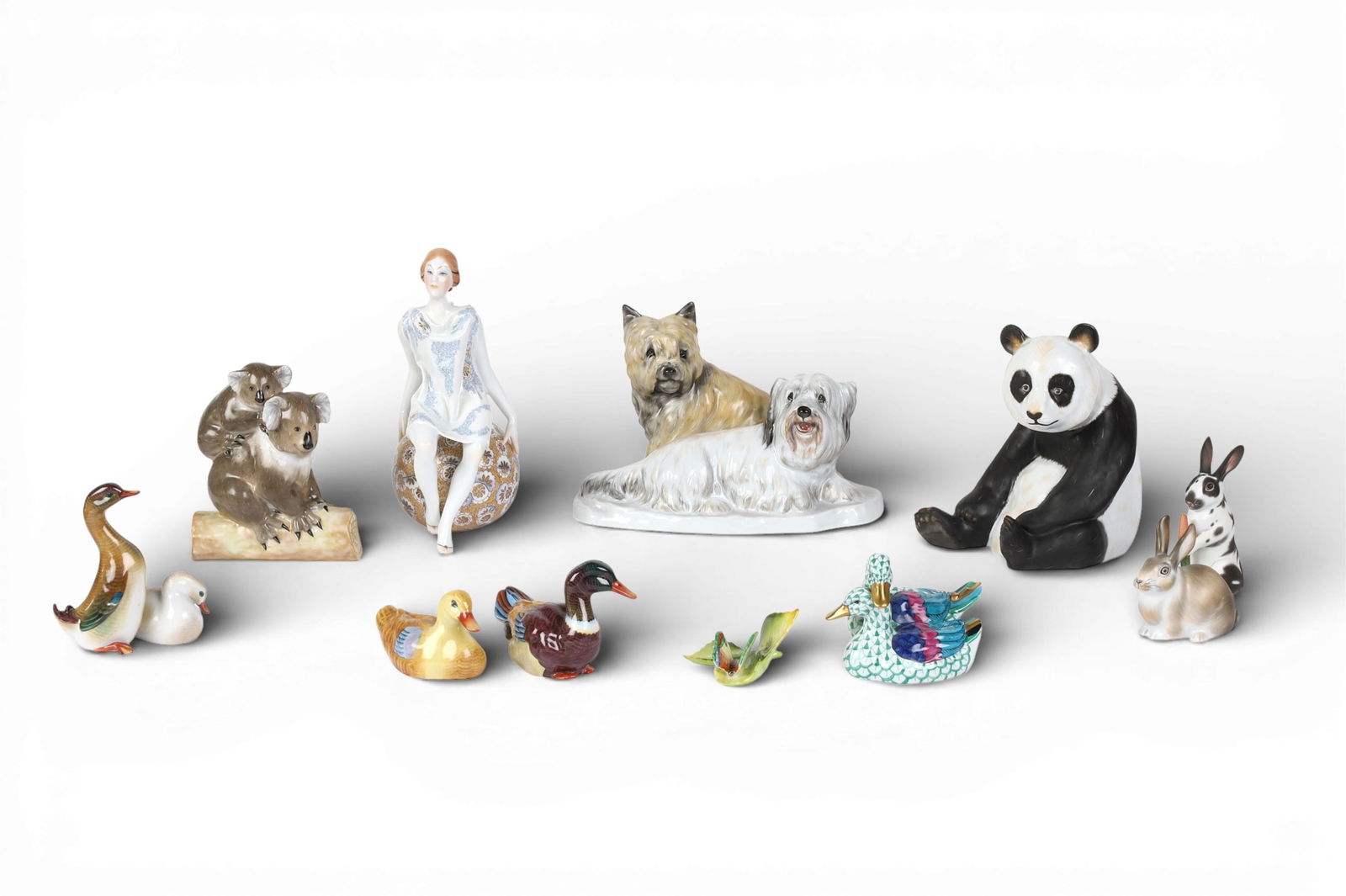 A group of eleven Herend porcelain figures: A group of eleven Herend porcelain figures Two terriers; height 6in (15cm); width8 1/2in (21.5cm); depth 5 1/4in (13cm) Provenance: Property from a Private Collection, Beverly Hills, California.