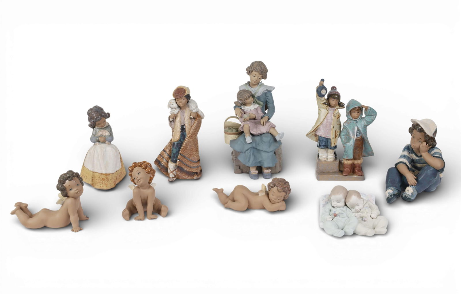 A group of nine Lladro figures: A group of nine Lladro figures Largest; height 11 1/2in (29cm); width 6 1/2in (16.5cm); depthin (15cm) Provenance: Property from a Private Collection, Beverly Hills, California.