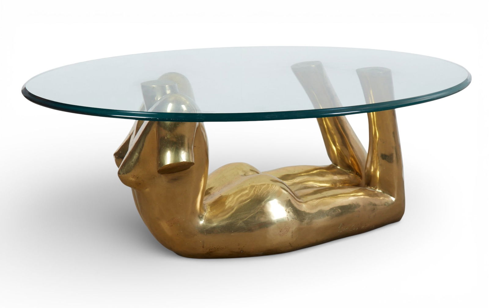 A bronze female form cocktail table: A bronze female form cocktail table sculpture base: 15 x 26 x 12 in. (38.1 x 66 x 30.5 cm.)