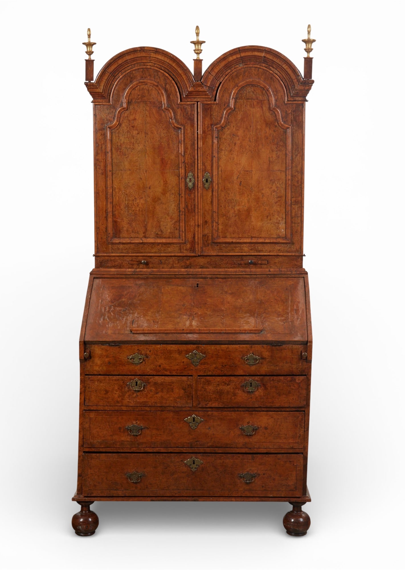 A Queen Anne burr elm and burr walnut double domed secretary cabinet, early 18th century: A Queen Anne burr elm and burr walnut double domed secretary cabinetearly 18th centuryThe upper section with a pair of domed doors enclosing an interior fitted with pigeonholes, a pair of adjustable s