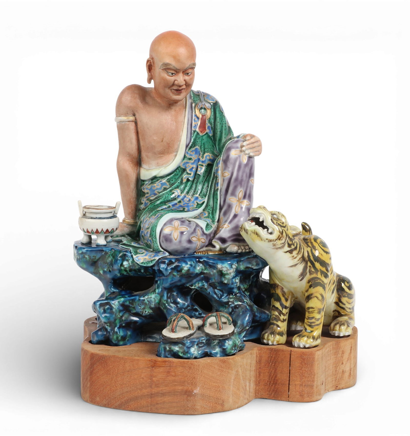 A Chinese polychrome decorated porcelain model of seated Luohan with tiger (1 of 6)