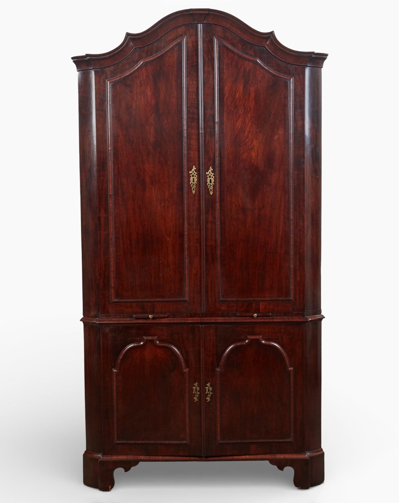 A George I style walnut corner cupboard, composed of antique and later elements: A George I style walnut corner cupboardcomposed of antique and later elementsThe upper section with three shaped shelves above candle slides, the lower section with one shelf.height 89 1/2in (227cm);