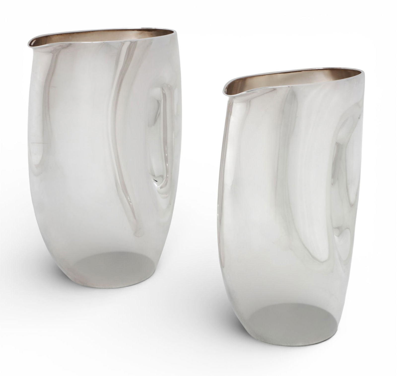 A pair of Eleonore Peduzzi Riva for De Vecchi sterling silver Jarra carafes / jugs, Milan, 2004: A pair of Eleonore Peduzzi Riva for De Vecchi sterling silver Jarra carafes / jugsMilan2004Numbered 14/99 and 15/99.height 9 1/2in (24cm); length 7in (18cm); width 4in (10cm); total weight approximate