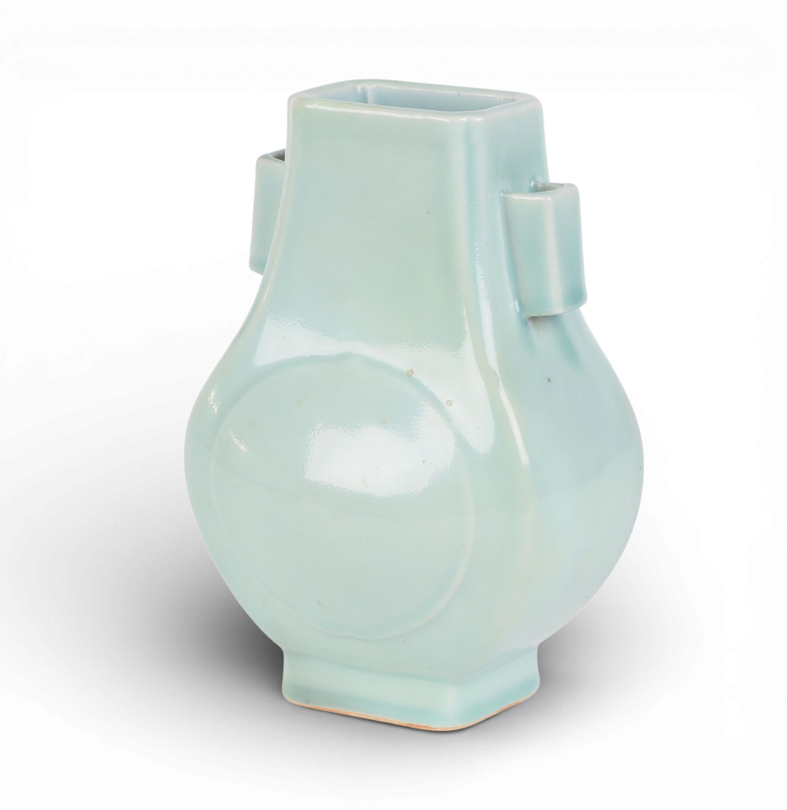 A Chinese celadon Fanghu form vase: A Chinese celadon Fanghu form vaseWith six character mark to underside.height 10 1/4in (26cm); width 6 1/2in (16.5cm); depth 5in (12.5cm) Provenance:Property from the Preiser Collection.