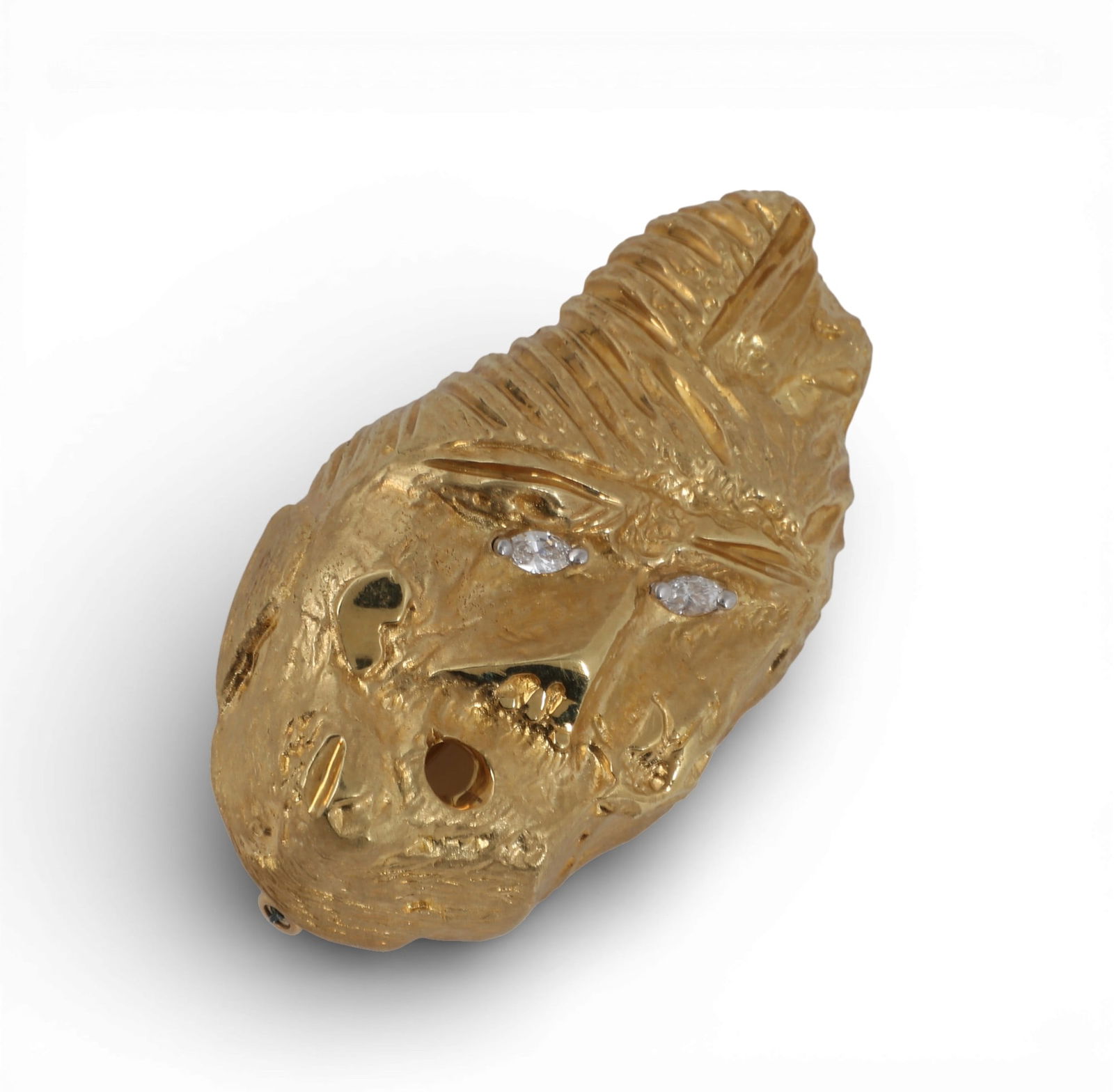 Henry Dunay: An 18K yellow gold and diamond brooch,approximately 2.15 x 1.25in (5.5 x 3cm); gross: Henry Dunay: An 18K yellow gold and diamond broochClip brooch depicting a distorted face with two marquise shape diamonds set in the eyes, estimated to weigh 0.20 carat total weight.approximately 2.15