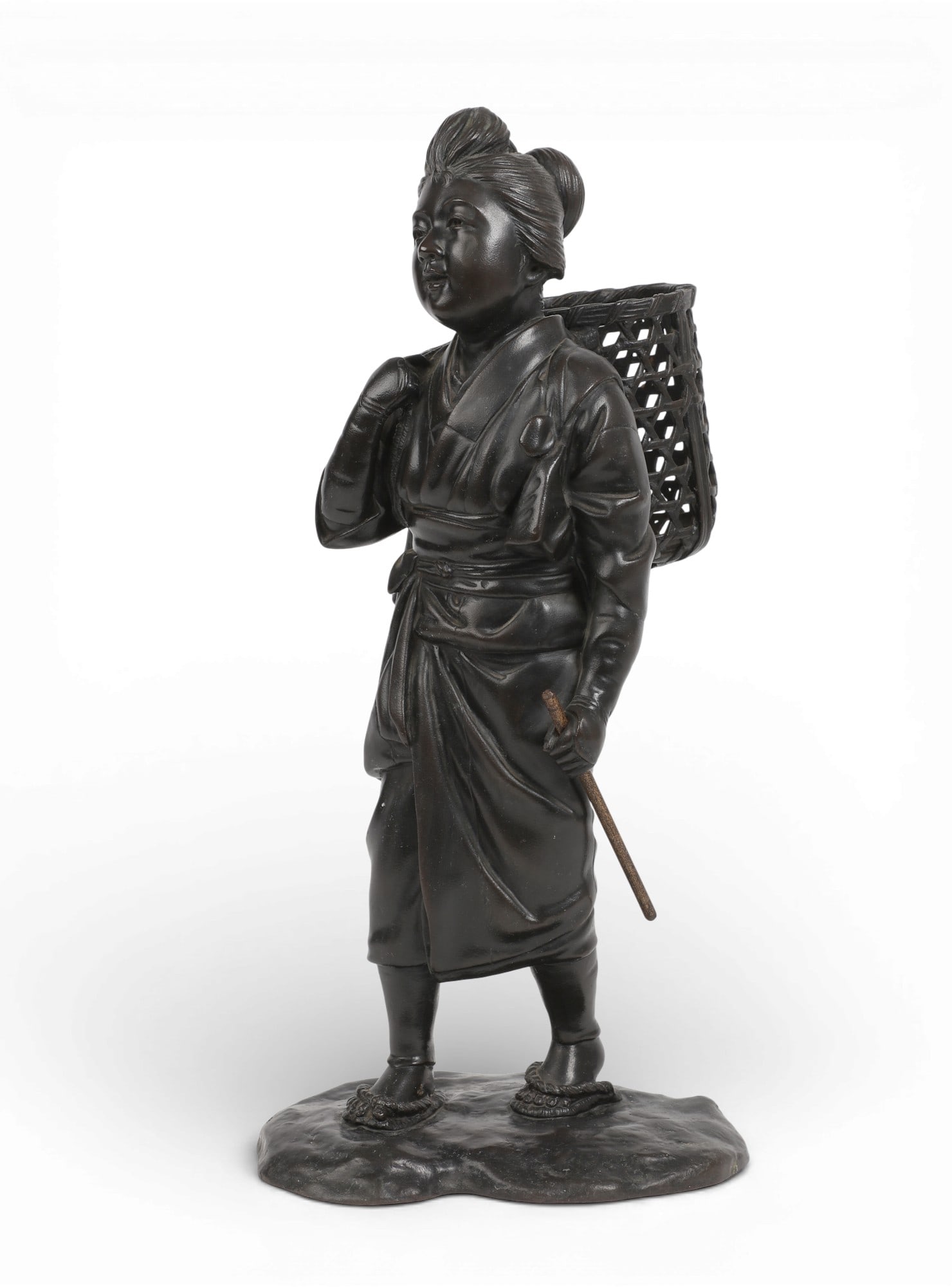 A Japanese bronze okimono of a woman carrying a basket: A Japanese bronze okimono of a woman carrying a basketheight 17in (43cm); width 8in (20cm); depth without rod 6 1/2in (16.5cm) Provenance:Property from a Private Collection, San Francisco, California.