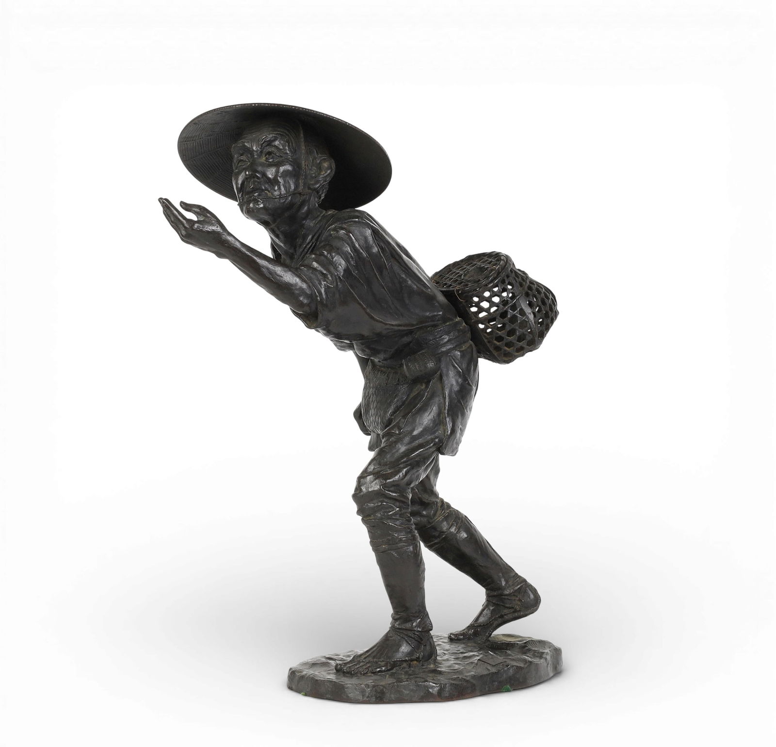 A large Japanese patinated bronze okimono of a fisherman: A large Japanese patinated bronze okimono of a fishermanSquare inscribed seal pad to top of base.height 20in (51cm); width 17 1/2in (44.5cm); depth 9 1/2in (24cm) Provenance:Property from a Private C