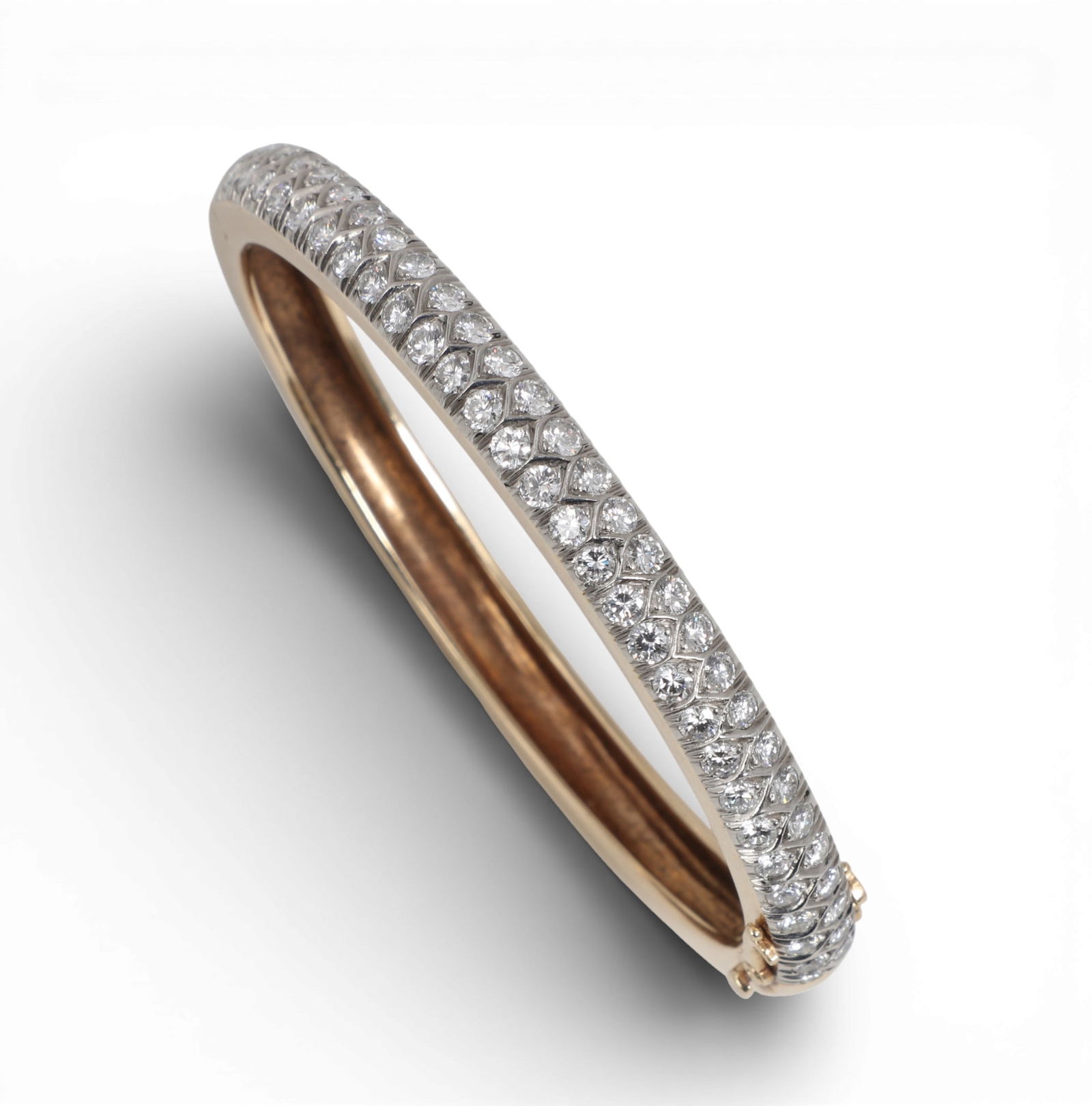 Laykin et Cie: A diamond and 14K yellow gold bangle bracelet,inside diameter measures approximately: Laykin et Cie: A diamond and 14K yellow gold bangle braceletHinged bangle set with round brilliant-cut diamonds, estimated to weigh 1.15 caratstotal weight.inside diameter measures approximately 2.25