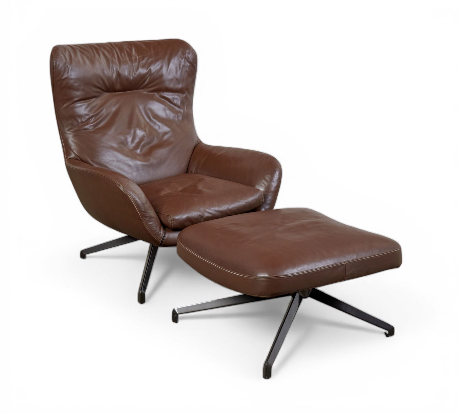 A Minotti Jensen leather arm chair with matching ottoman: A Minotti Jensen leather arm chair with matching ottoman Chair : height 36 x width 31 x depth 37 in. (91.4 x 78.7 x 94 cm.)
