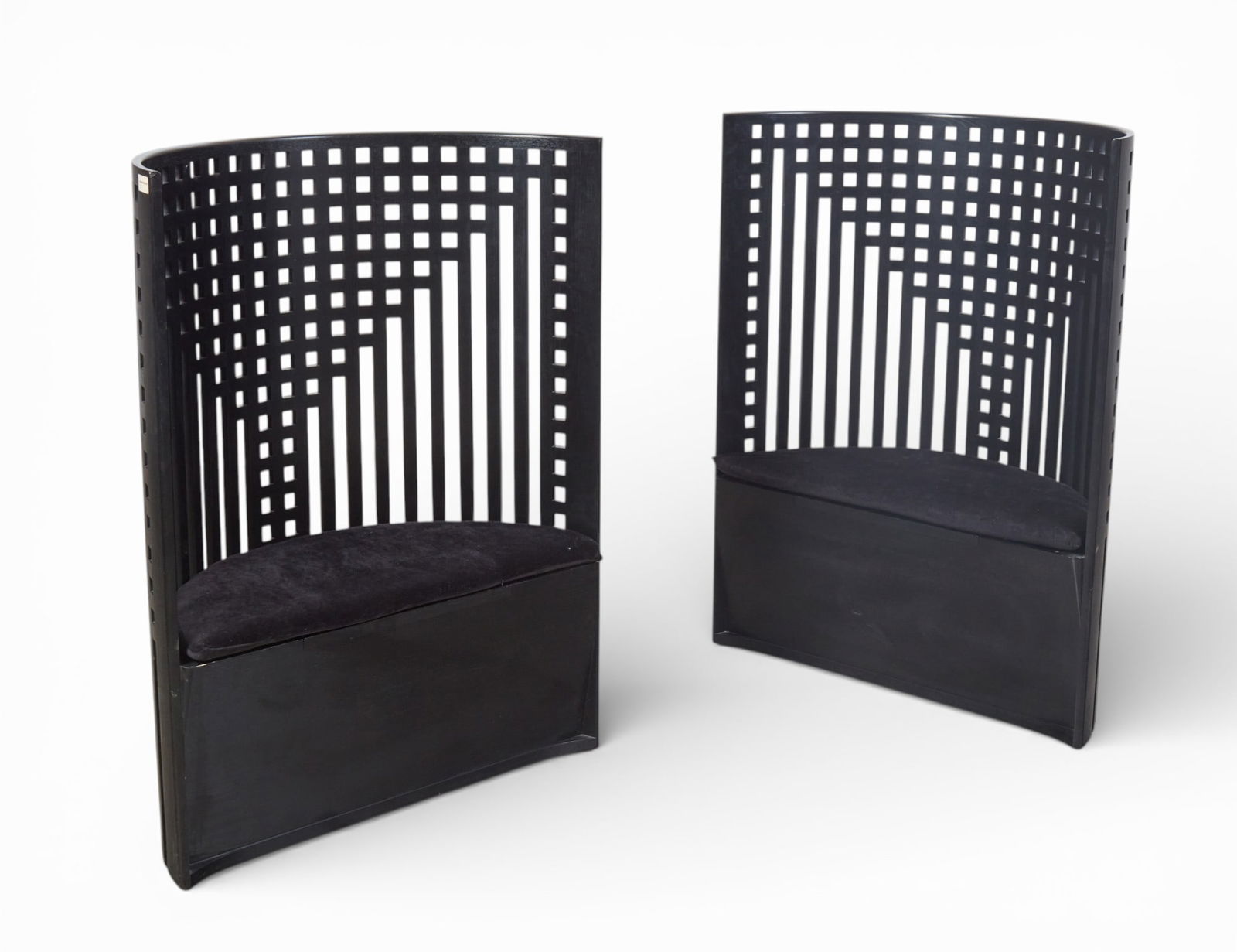 A pair of Charles Rennie Mackintosh ebonized willow chairs, Cassina, post 1950: A pair of Charles Rennie Mackintosh ebonized willow chairs Cassina post 1950 Each with a hinged storage compartment beneath the cushions, inscribed Cassina Charles Rennie Mackintosh, one stamped 1652,