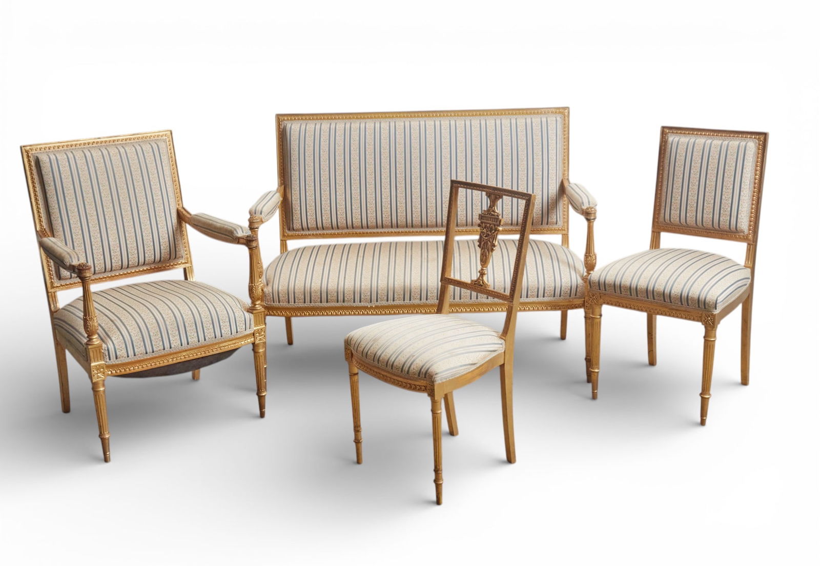 A four piece giltwood salon set consisting of canape, armchair and two side chairs: A four piece giltwood salon set consisting of canape, armchair and two side chairs Canape: height 37 x width 49 x depth 21 in. (94 x 124.5 x 53.3 cm.)