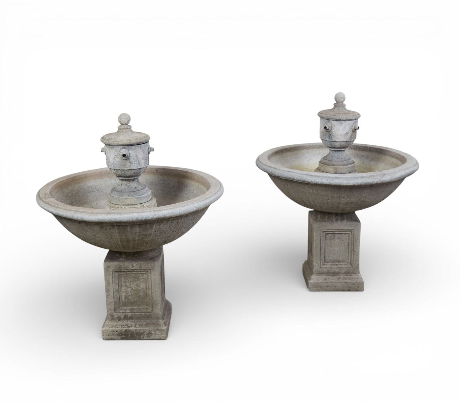A pair of cast stone fountains: A pair of cast stone fountains height 36 x diameter 29 in. (91.4 x 73.7 cm.)