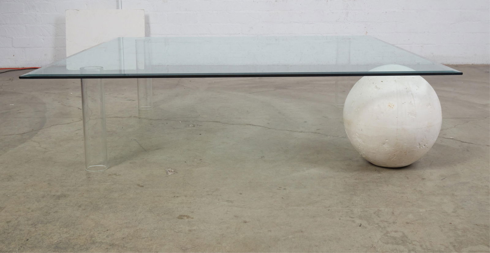 A Modernist glass cocktail/coffee table: A Modernist glass cocktail/coffee table height 15in (38cm); width 60in (152cm) square