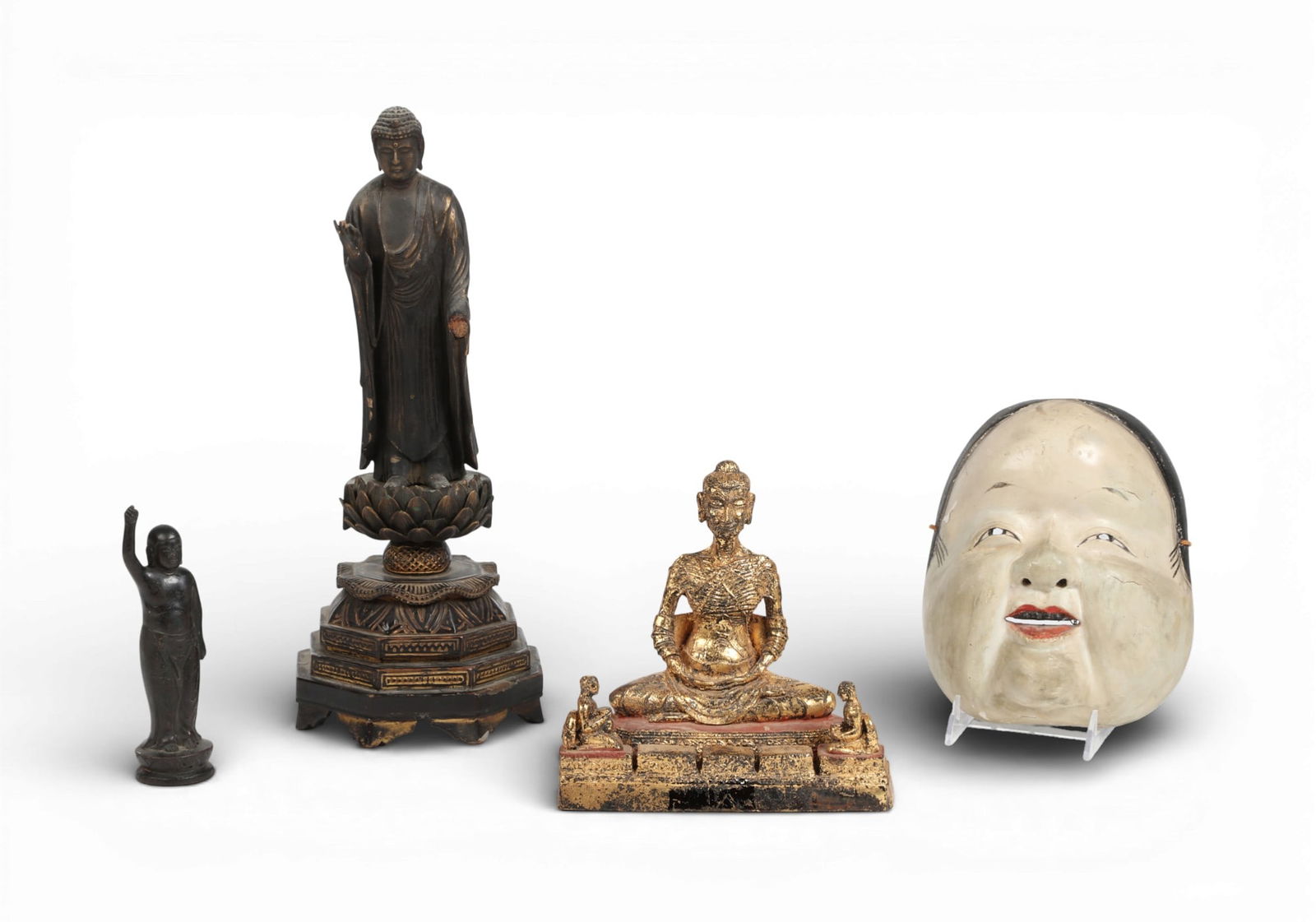 Three Japanese mixed media votive figures and a noh mask: Three Japanese mixed media votive figures and a noh maskComprising a model of Amitabha Buddha, a model of Buddha as a child, a model of Sakkyamuni as ascetic and a noh maskAmitabha Buddha height 17in