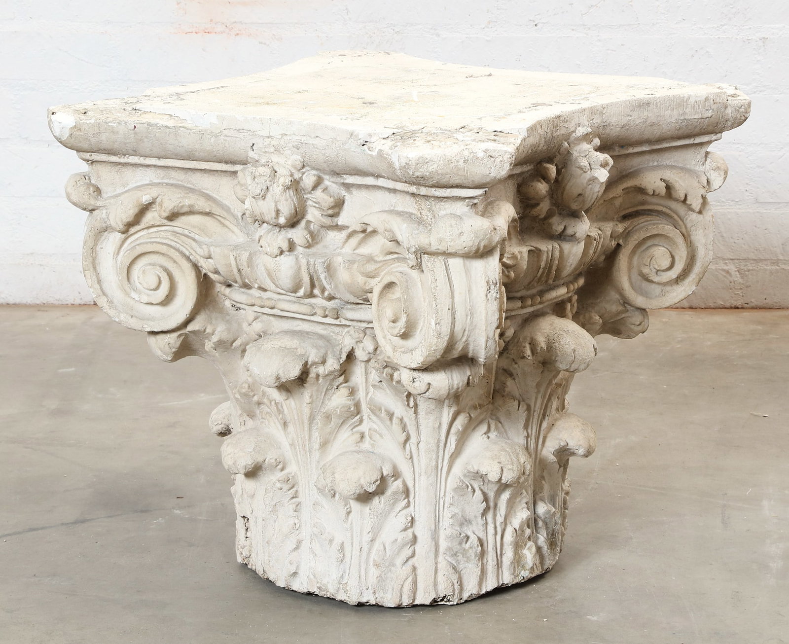 A cast stone Corinthian capital table base, post 1950: A cast stone Corinthian capital table base post 1950 height 23in (58.5cm); width 25in (63.5cm) square Provenance: Sold in these Rooms, 8 August 2023, lot 533.