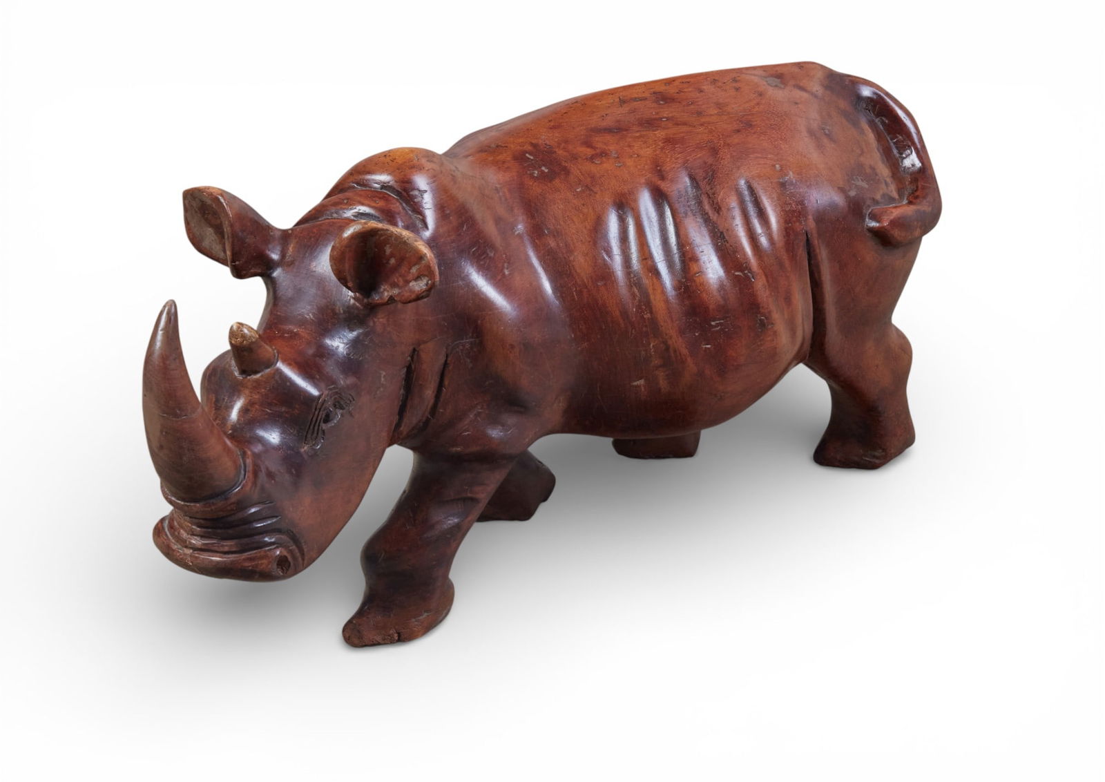 A carved hardwood model of a rhinoceros, 20th century: A carved hardwood model of a rhinoceros20th centuryheight 16in (41m); length 33 1/2in (85cm)