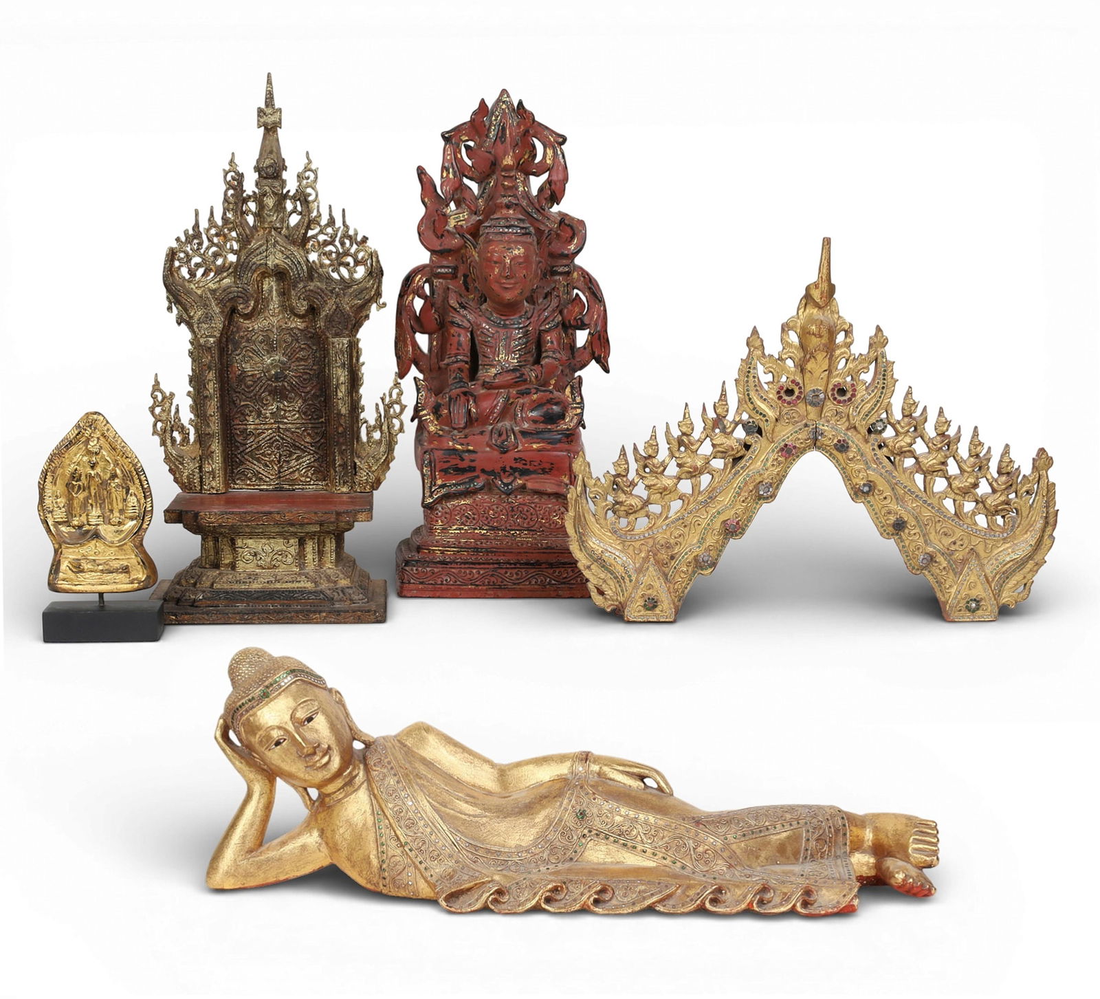 Five Southeast Asian gilt and embellished figures and votive pieces, mostly Burmese: Five Southeast Asian gilt and embellished figures and votive piecesmostly BurmeseComprising a gilt pottery Phra stele, a model of Buddha in Parinirvana, a giltwood palin/throne, a temple panel and a p