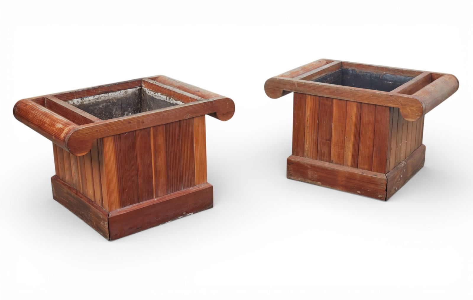 A pair of Modernist stained pine Ionic capital form jardinieres, late 20th/early 21st century: A pair of Modernist stained pine Ionic capital form jardinieres late 20th/early 21st century height 22 1/2in (57cm); width 35 1/2in (90cm); depth 24 1/2in (62cm) Provenance: Property from a Private