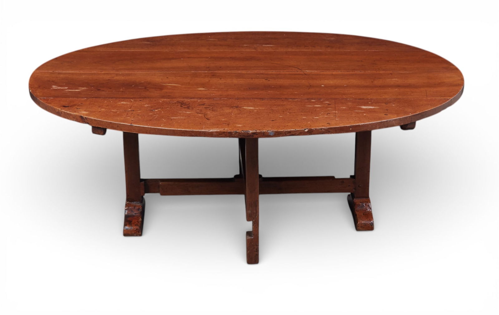 A French provincial walnut oval coffee table, 19th century: A French provincial walnut oval coffee table 19th century height 20 1/2in (52cm); width 56in (143cm); depth 45in (115cm)