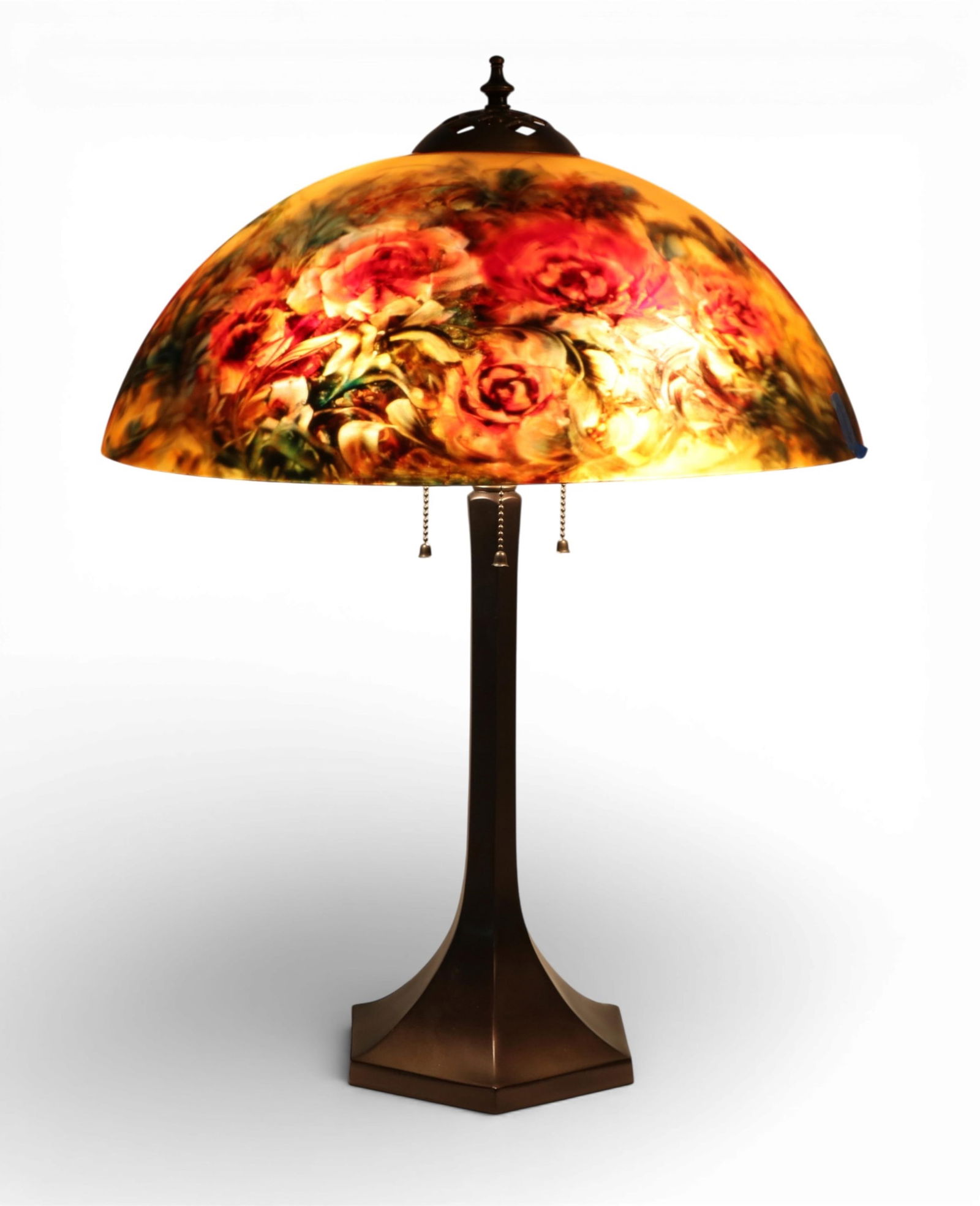 An Ulla Darni reverse painted glass red floral lamp shade on associated base: An Ulla Darni reverse painted glass red floral lamp shade on associated patinated metal baselate 20th centuryShade with painted signature ULLA to interior.height 25 1/2in (64cm); diameter 18 1/2in (46
