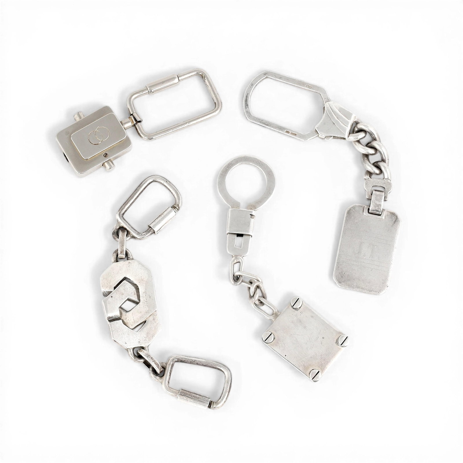 A group of three sterling silver keychains together with a vintage Gucci keychain, (4), approx 85: A group of three sterling silver keychains together with a vintage Gucci keychain (4) approx 85 grams approximately 85g sterling silver