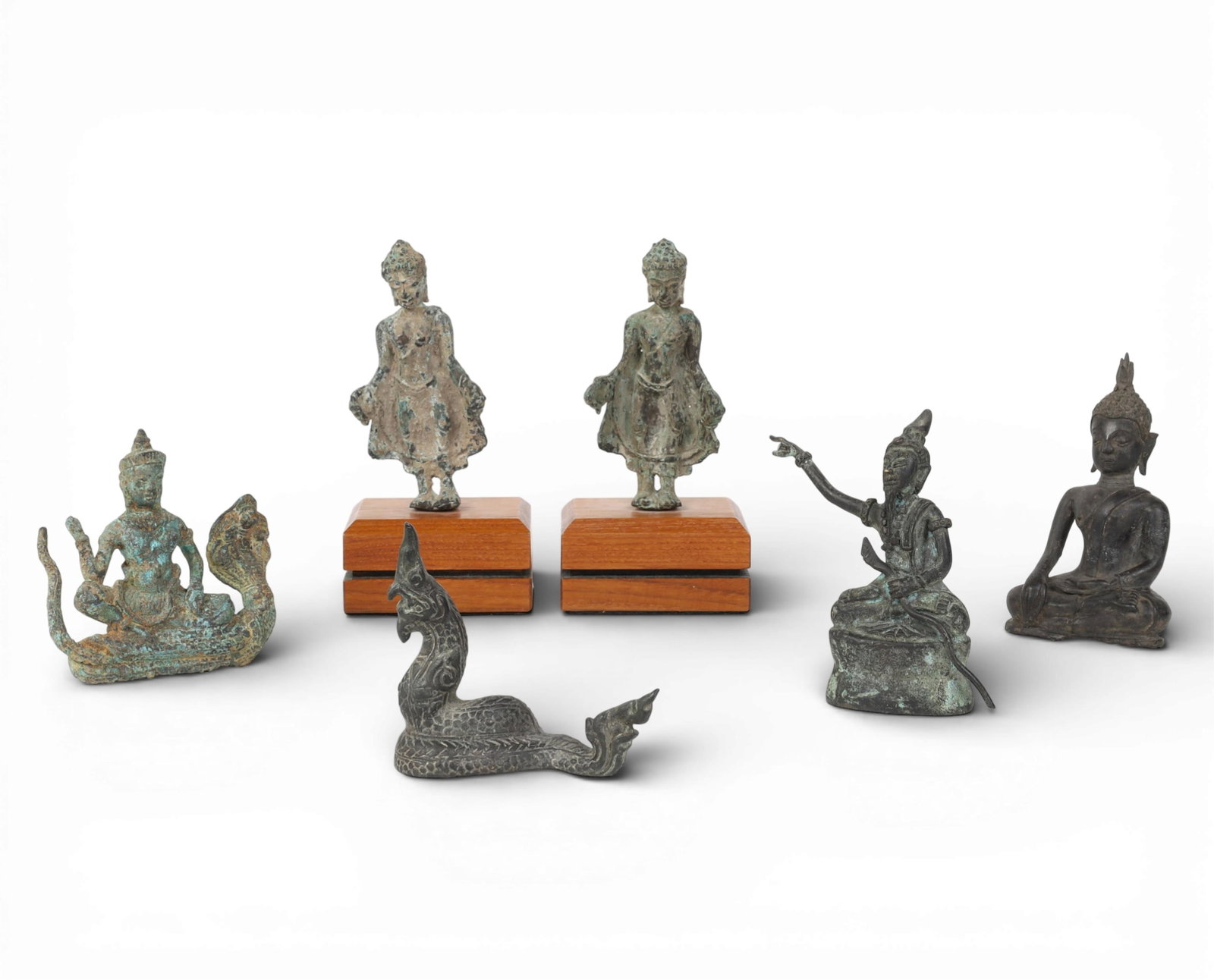 Six Southeast Asian bronze votive figures: Six Southeast Asian bronze votive figures Including models of Buddha, Lersi and others, two on plinths. largest overall height 8in (20cm); width 4in (10cm); depth 3in (7.5cm) Provenance: Property