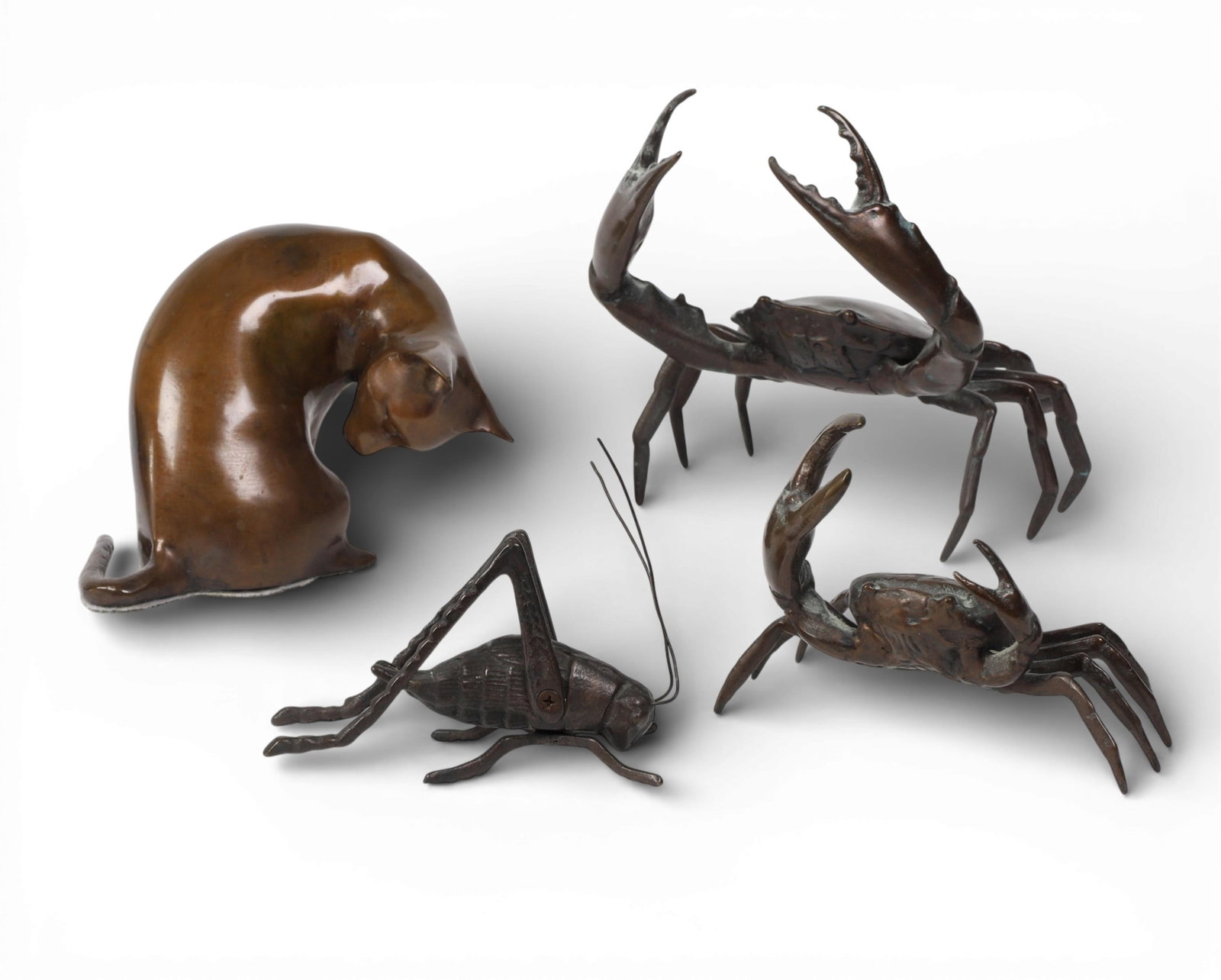 Four patinated bronze models of animals, modern: Four patinated bronze models of animals modern Comprising two crabs, a grasshopper, and a cat. largest crab height 7in (17.5cm); width 7in (17.5cm); depth 6 1/2in (16cm) Provenance: Property from a