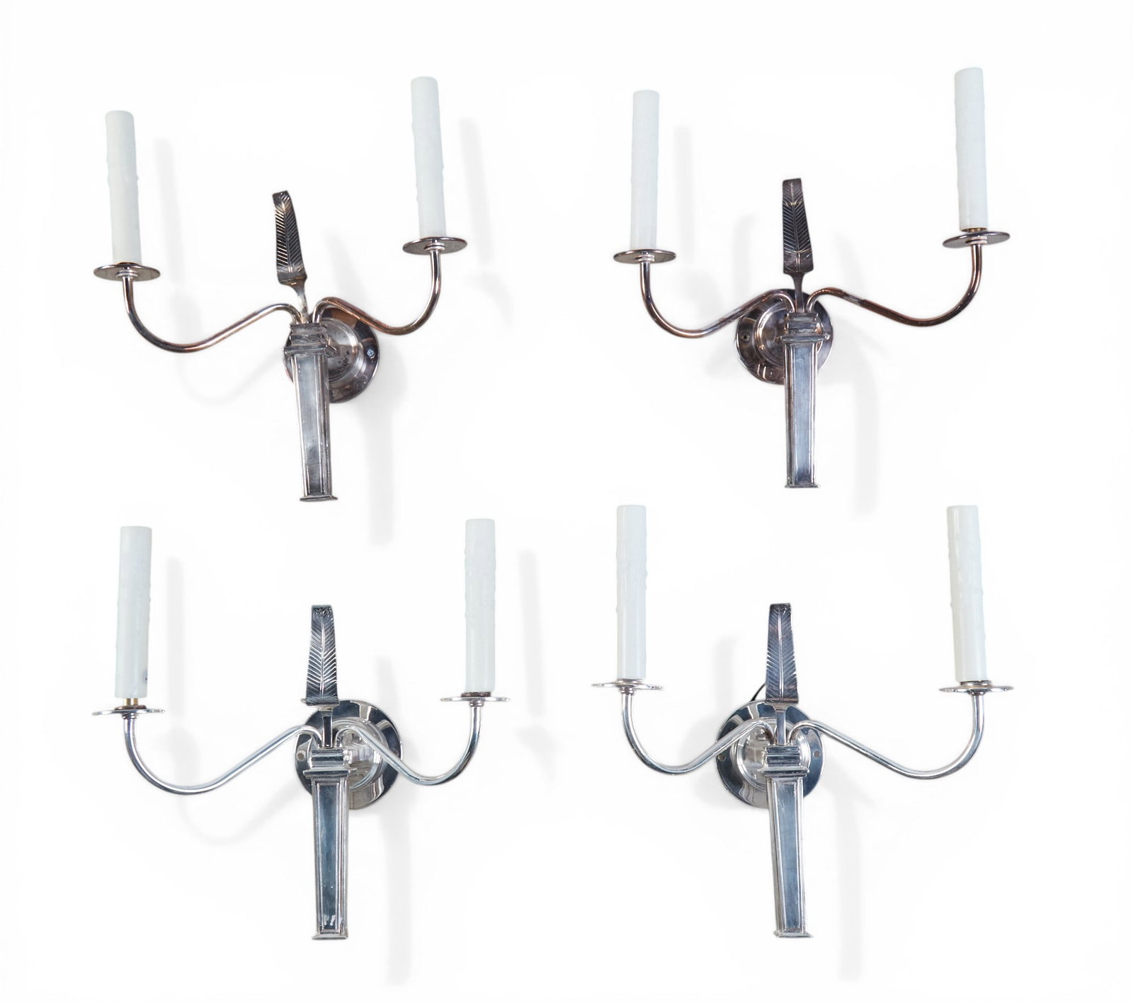 A group of four two light wall sconces in a polished, nickel finish: A group of four two light wall sconces in a polished nickel finish height 15 1/2 x width 13 1/2 in. (39.4 x 34.3 cm.)