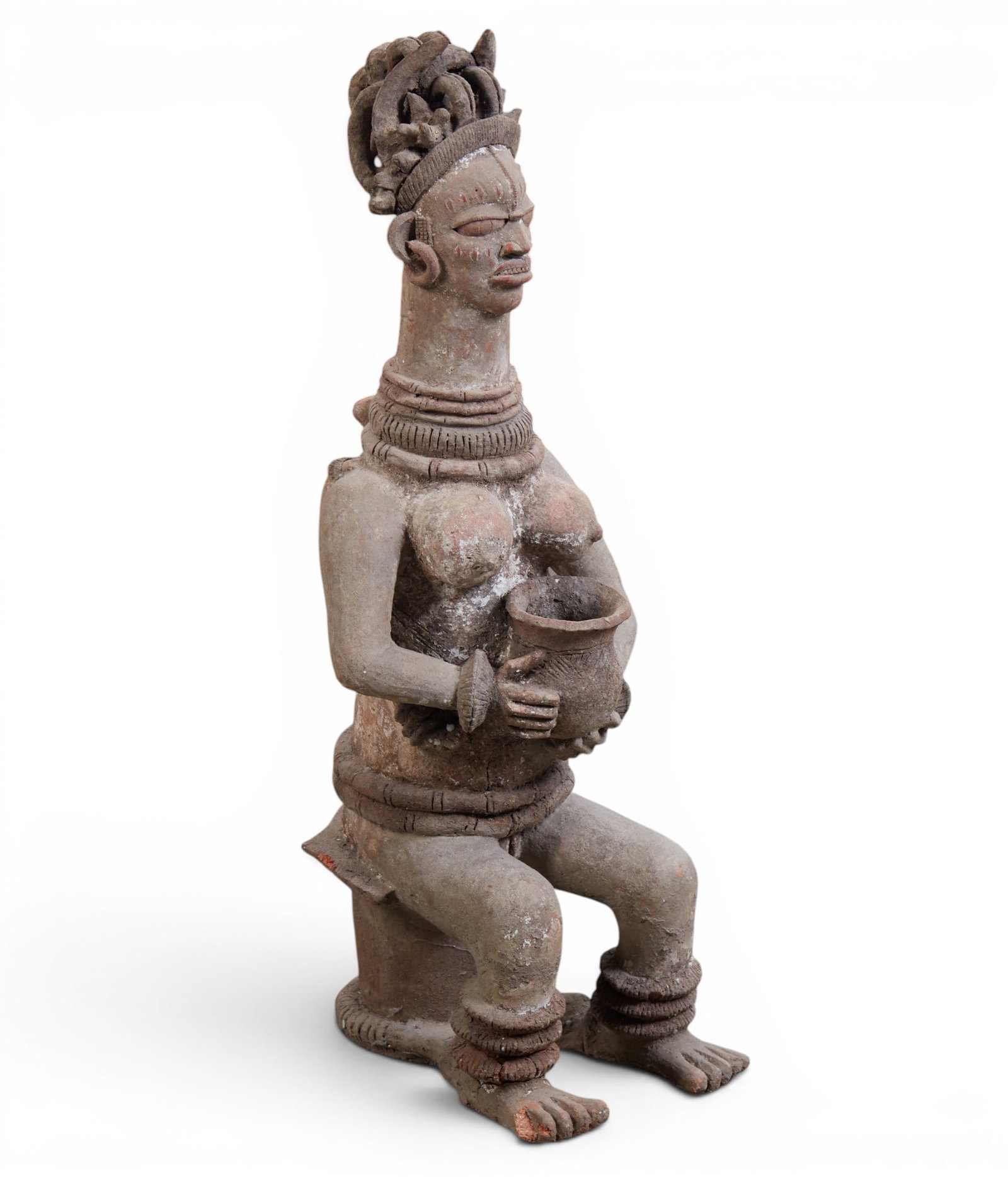 A terracotta Nok culture (Nigeria) seated figure: A terracotta Nok culture (Nigeria) seated figure height 43 x width 16 x depth 15 in. (109.2 x 40.6 x 38.1 cm.)