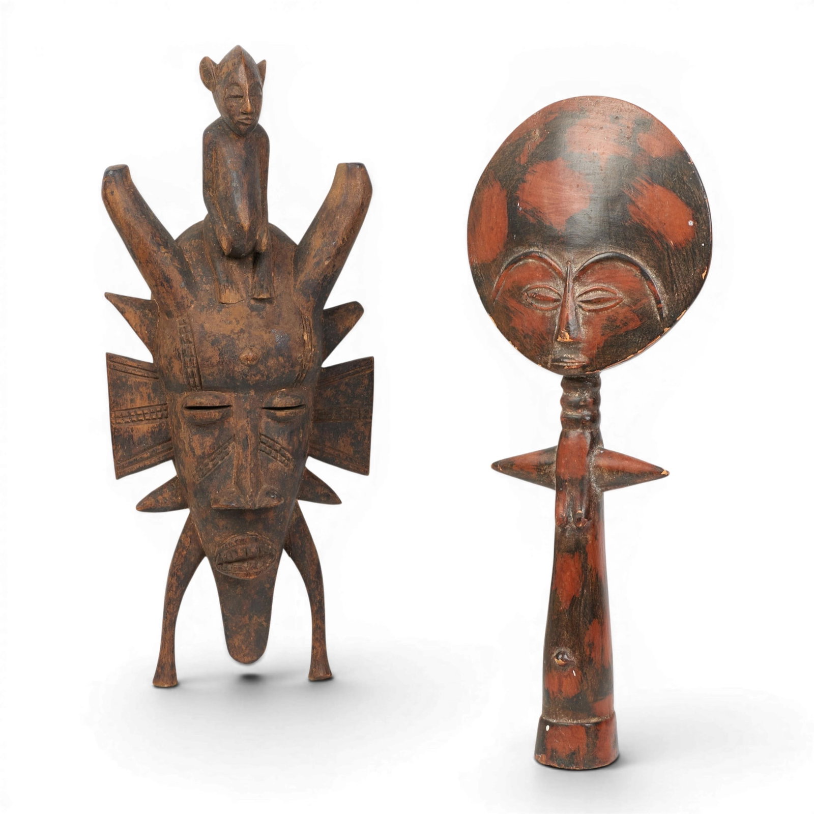 A group of two African carvings: A group of two African carvings Mask: height 19 x width 8 in. (48.3 x 20.3 cm.)