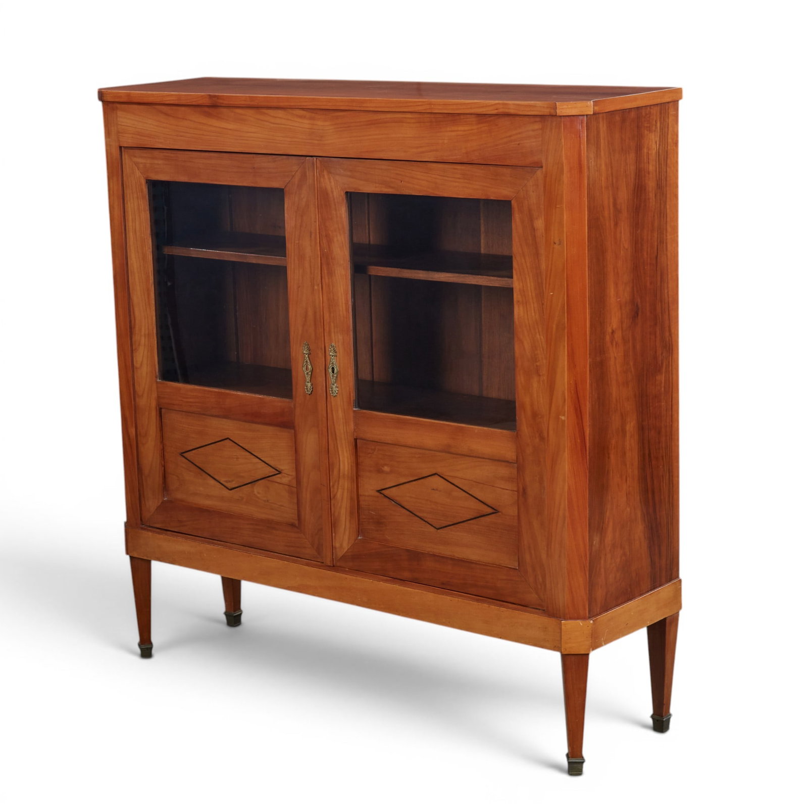 A Biedermeier two door cabinet: A Biedermeier two door cabinet height 49 x width 48 x depth 14 in. (124.5 x 121.9 x 35.6 cm.)