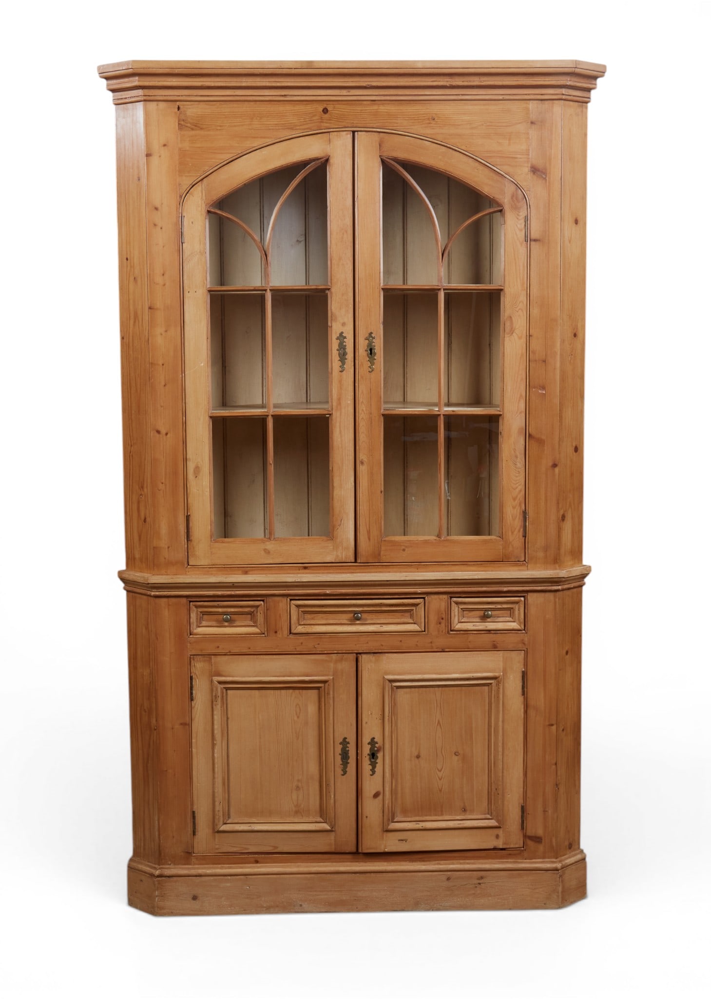 An English pine corner cabinet: An English pine corner cabinet height 84 x width 48 x depth 24 in. (213.4 x 121.9 x 61 cm.)