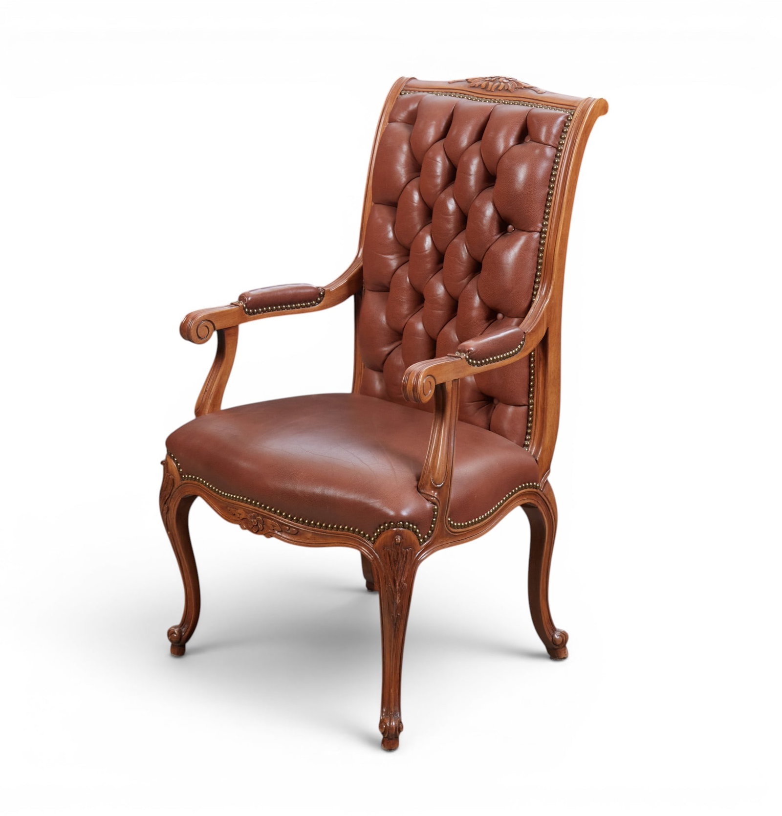 A tufted brown leather armchair: A tufted brown leather armchair height 42 x width 24 x depth 21 in. (106.7 x 61 x 53.3 cm.)