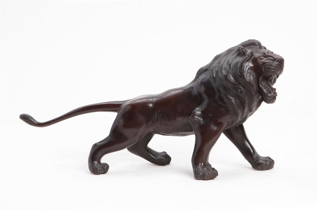 A Japanese patinated bronze model of a standing lion 20th century: A Japanese patinated bronze model of a standing lion 20th century