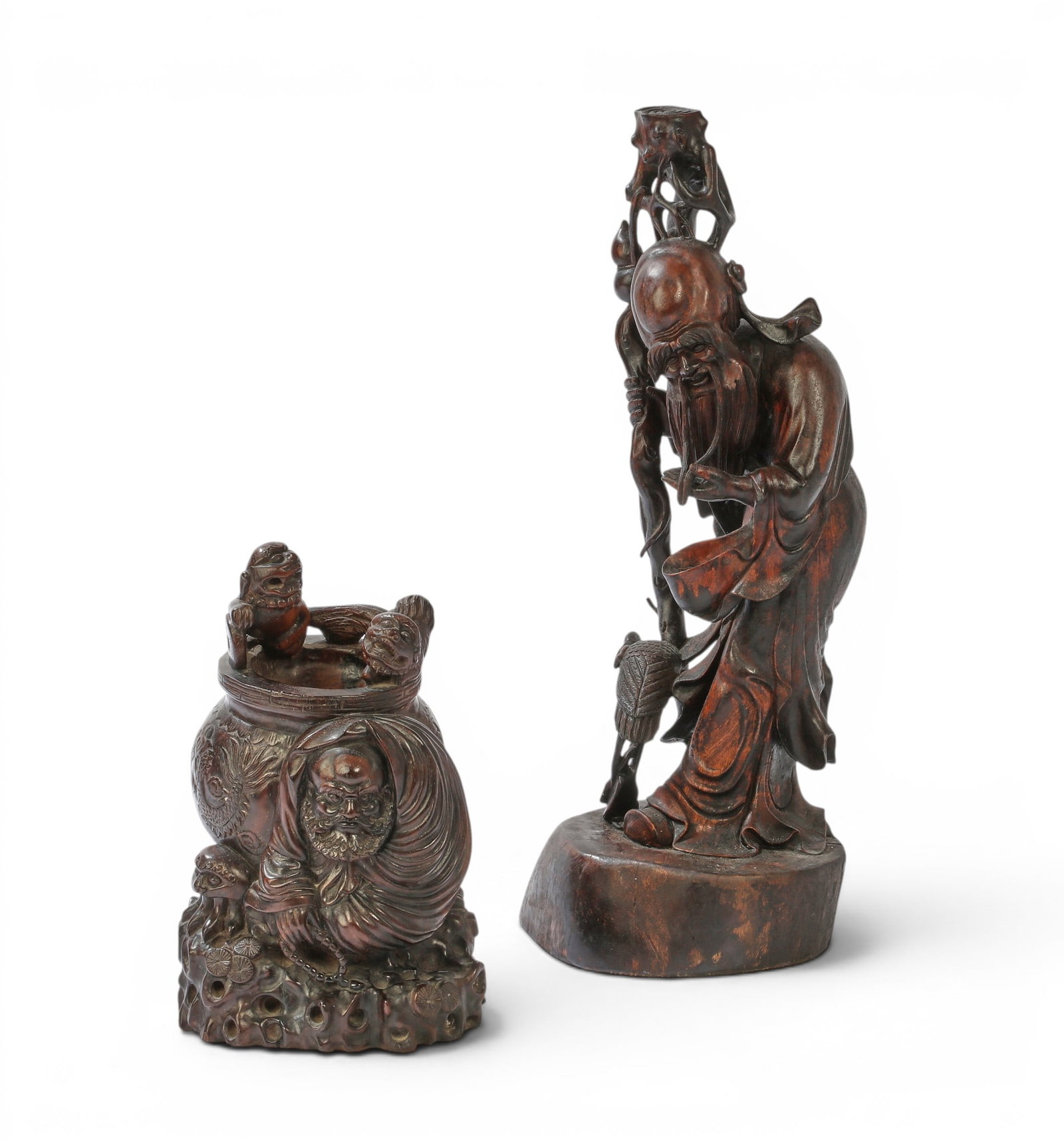 A group of two Chinese wood carvings: A group of two Chinese wood carvings Tallest: height 22 x width 8 x depth 8 in. (55.9 x 20.3 x 20.3 cm.)