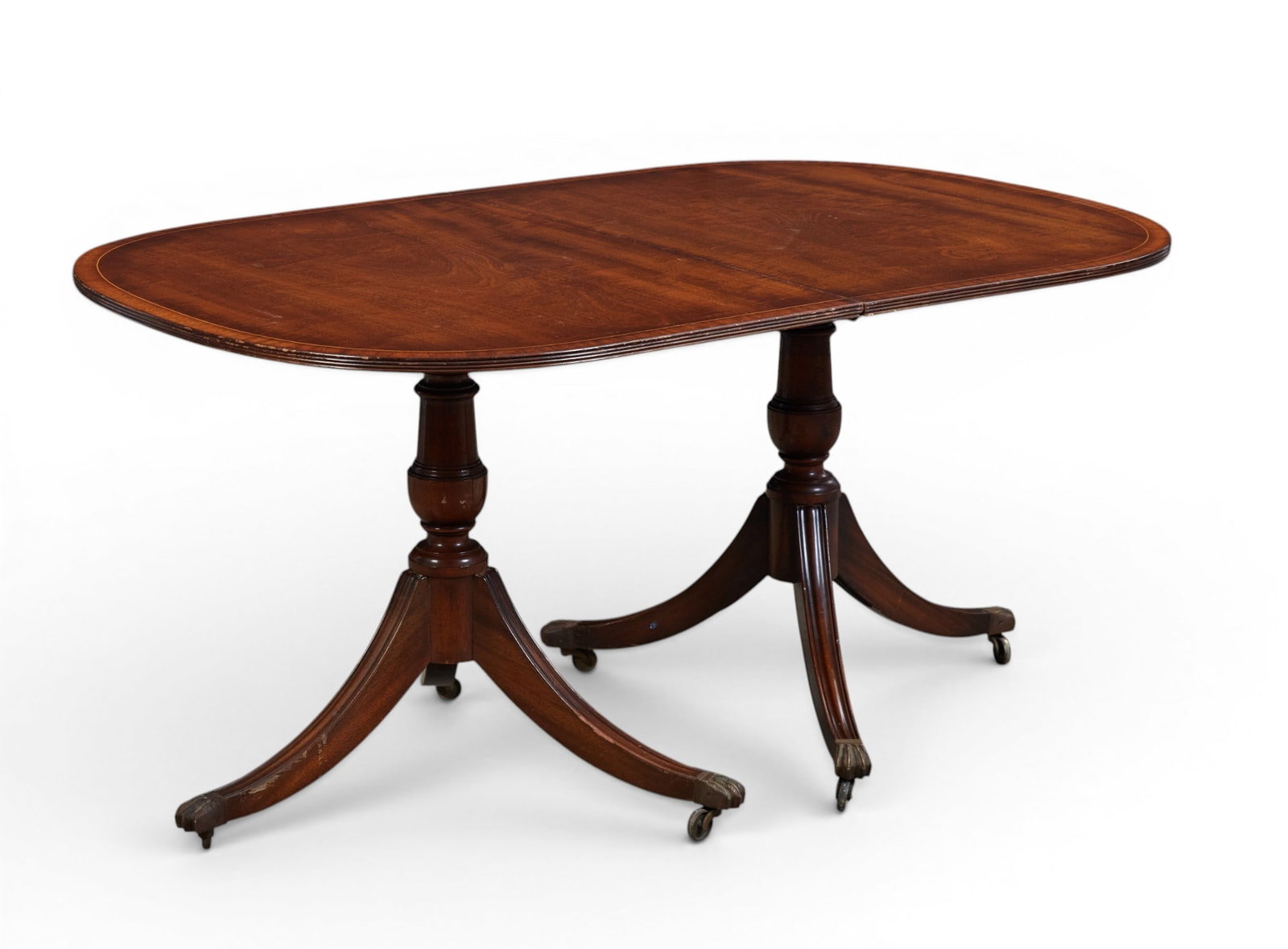 A mahogany two pedestal dining room table: A mahogany two pedestal dining room table height 29 x width 39 x length 60 in. (73.7 x 99.1 x 152.4 cm.)