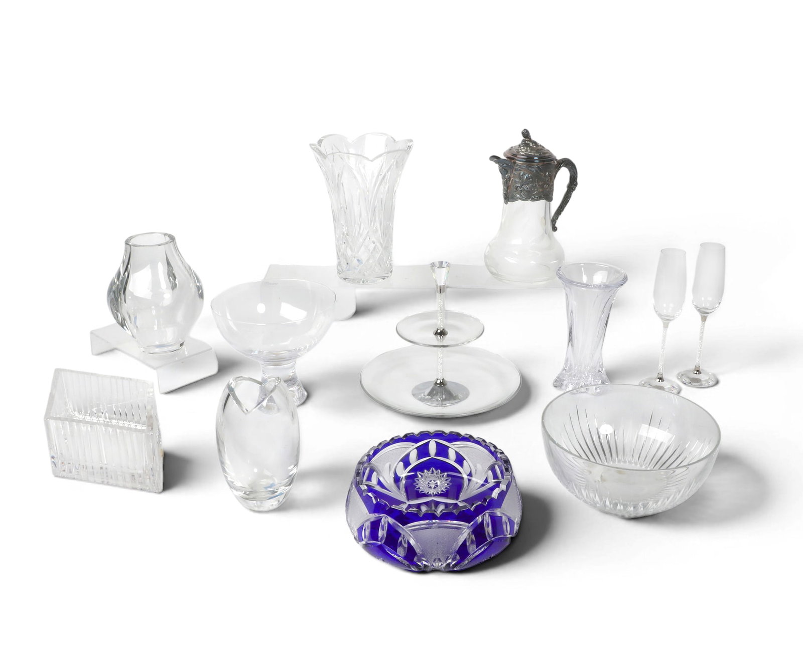 An assembled collection of clear glass table decorations, St Louis, Kosta Boda, Waterford,: An assembled collection of clear glass table decorations St Louis, Kosta Boda, Waterford, Swarovski, and others late 19th / 20th century Comprising a St Louis Univers vase, a Waterford Glenfall vase,